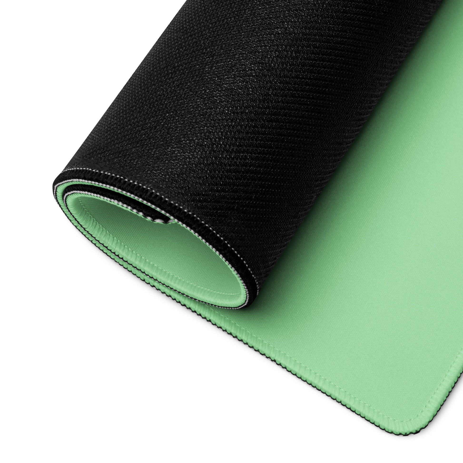 A 36" x 18" desk pad with a cute tree on it rolled up. Green in color.