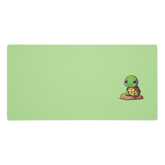 A 36" x 18" desk pad with a picture of a cute turtle sitting on a rock. Green in color.