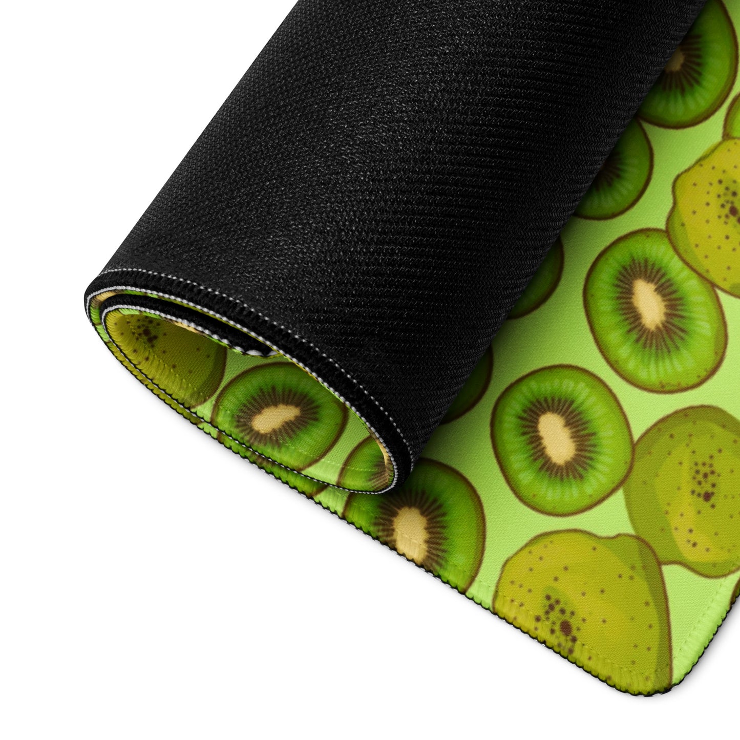 A 36" x 18" desk pad with Kiwis all over it rolled up. Green in color.