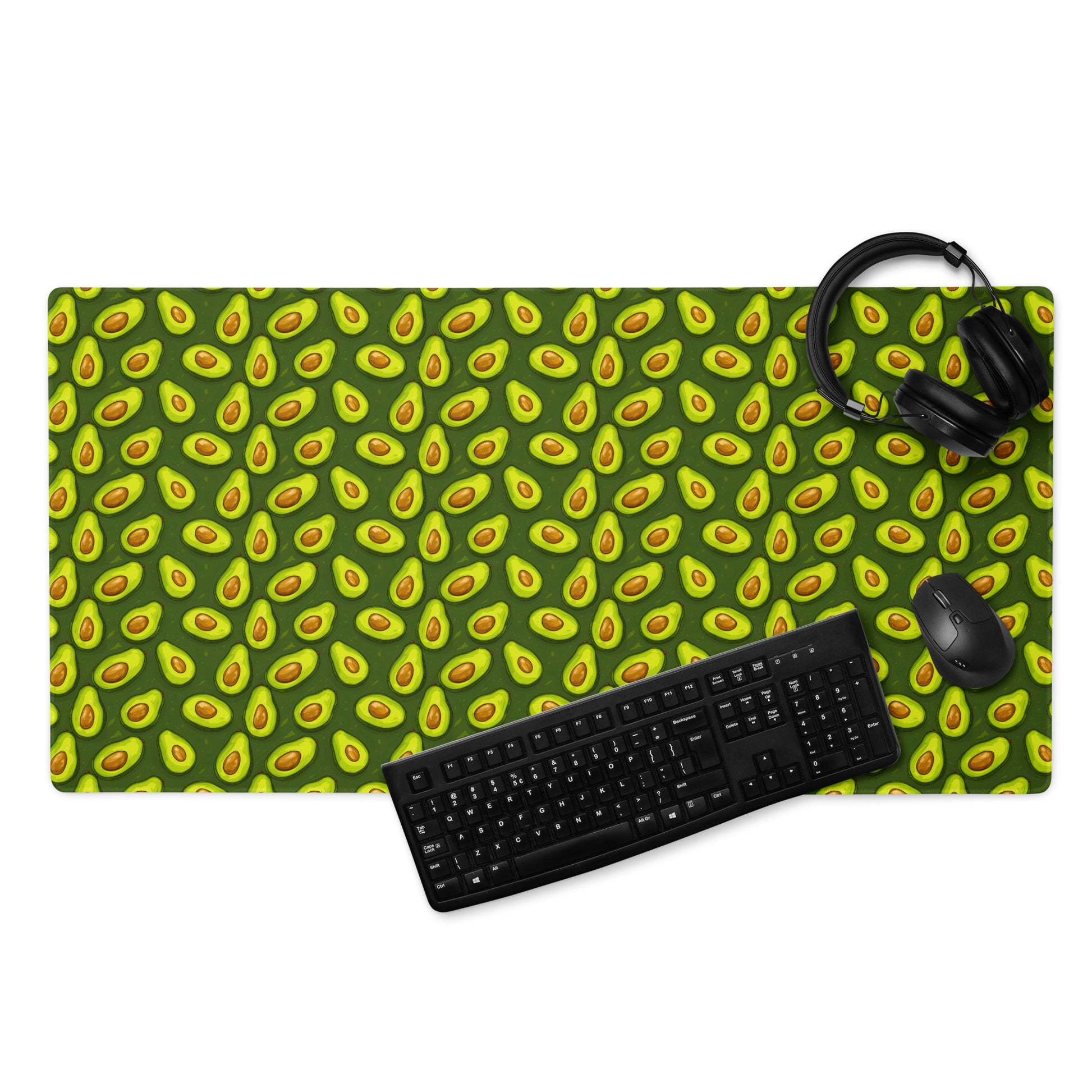 A 36" x 18" desk pad with lots of avocados on it displayed with a keyboard, headphones and a mouse on it. Green in color.
