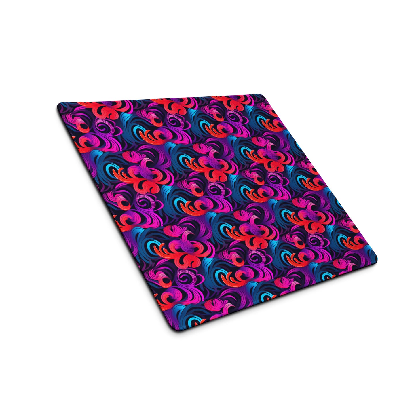 An 18" x 16" desk pad with a bright floral pattern all over it shown at an angle. Blue, Purple and Red in color.