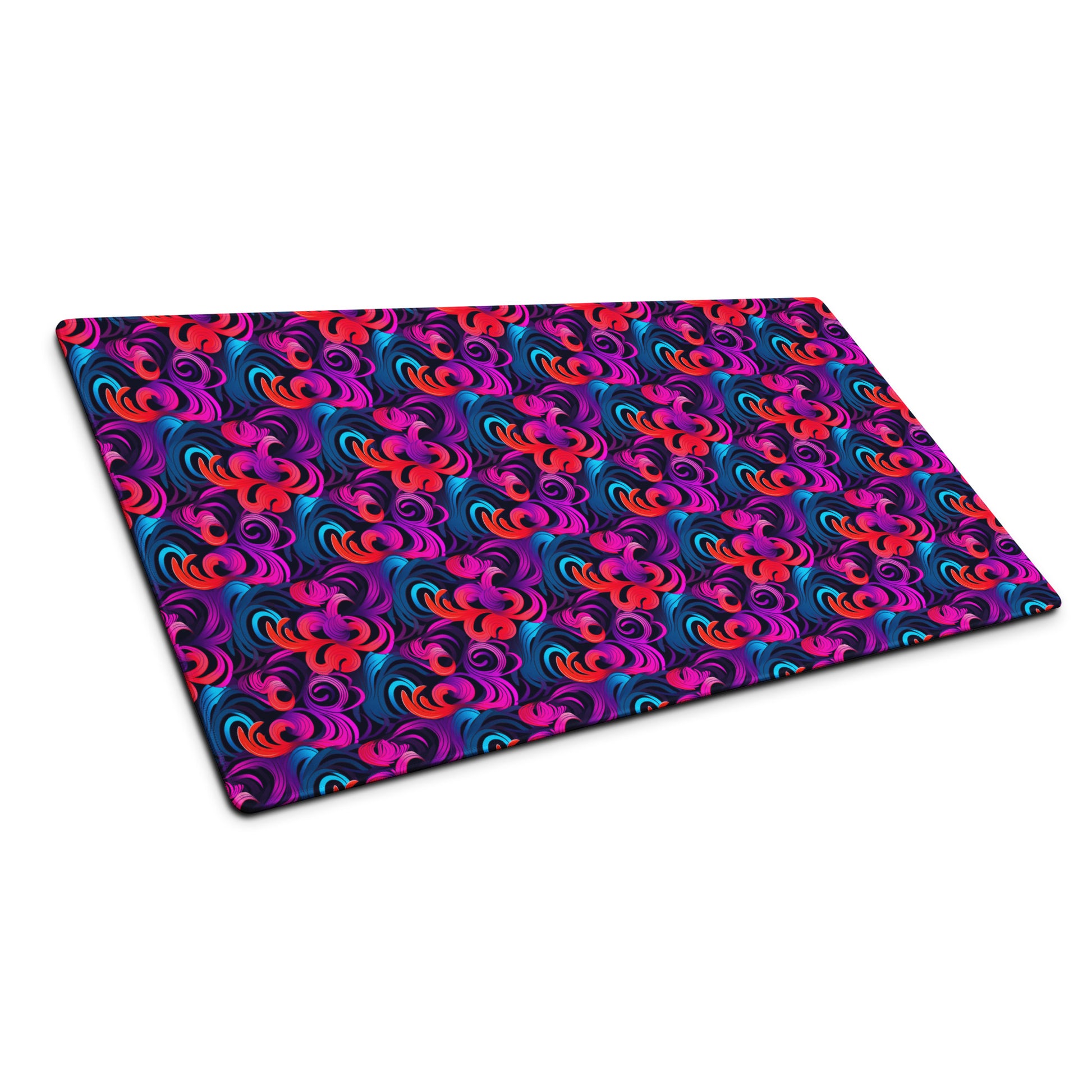 A 36" x 18" desk pad with a bright floral pattern all over it shown at an angle. Blue, Purple and Red in color.