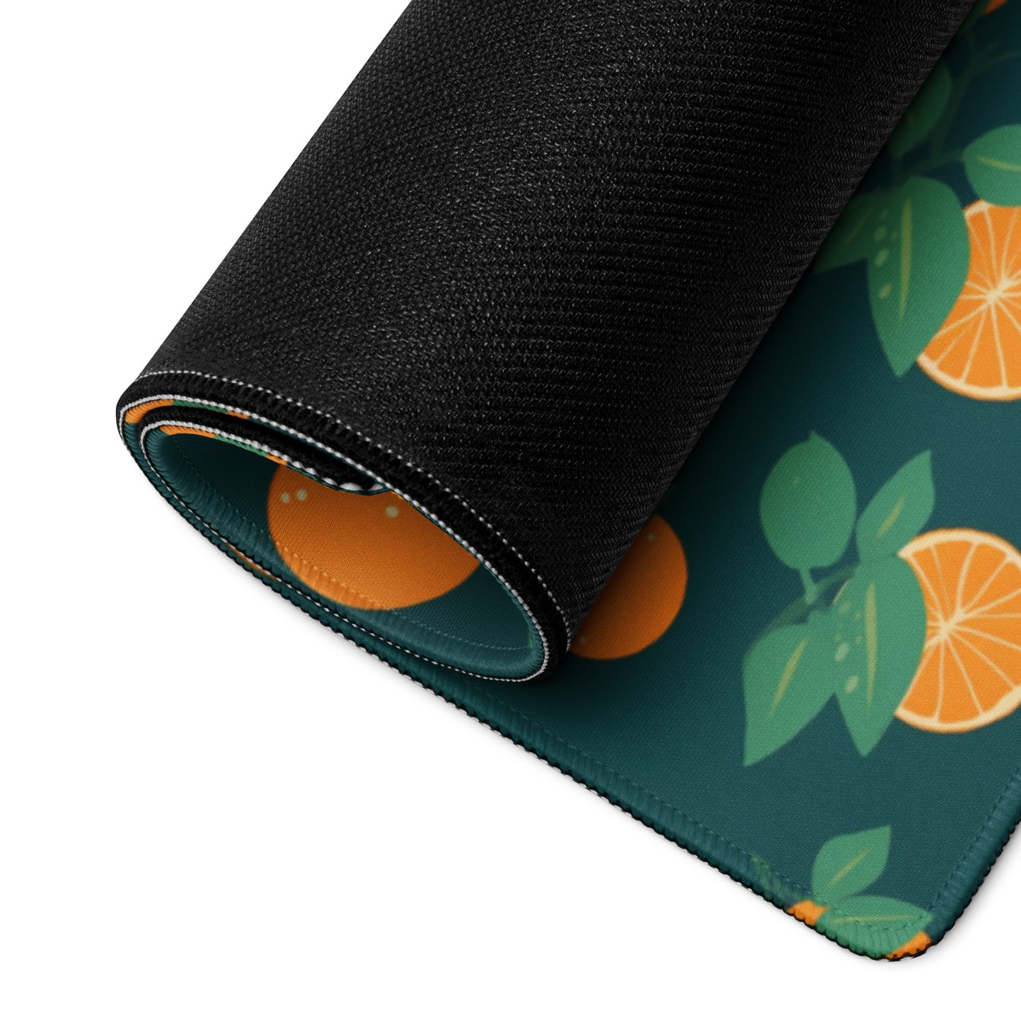 A 36" x 18" desk pad with oranges all over it rolled up. Orange and Blue in color.