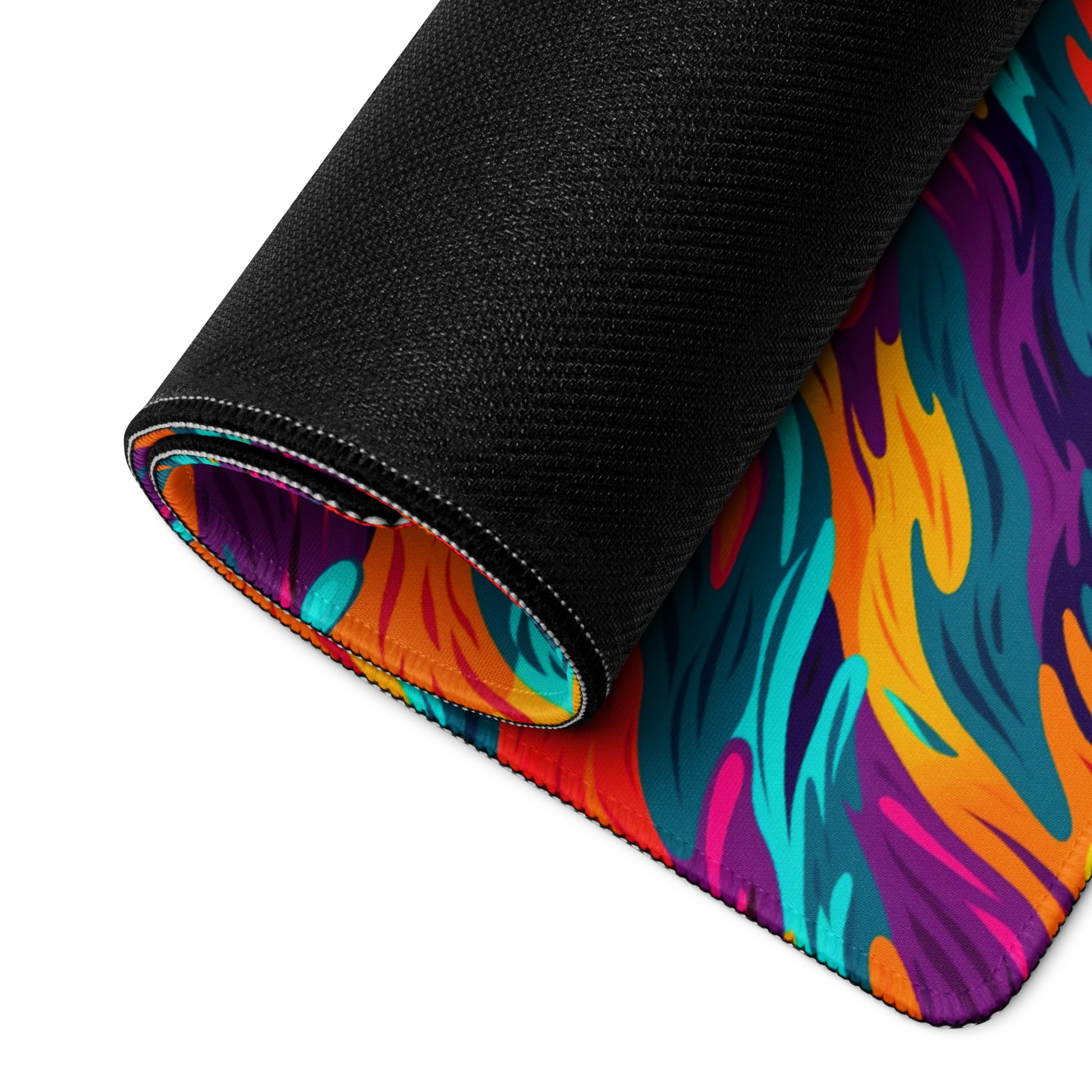 A desk pad with a wavy flame pattern on it rolled up. Rainbow in color.