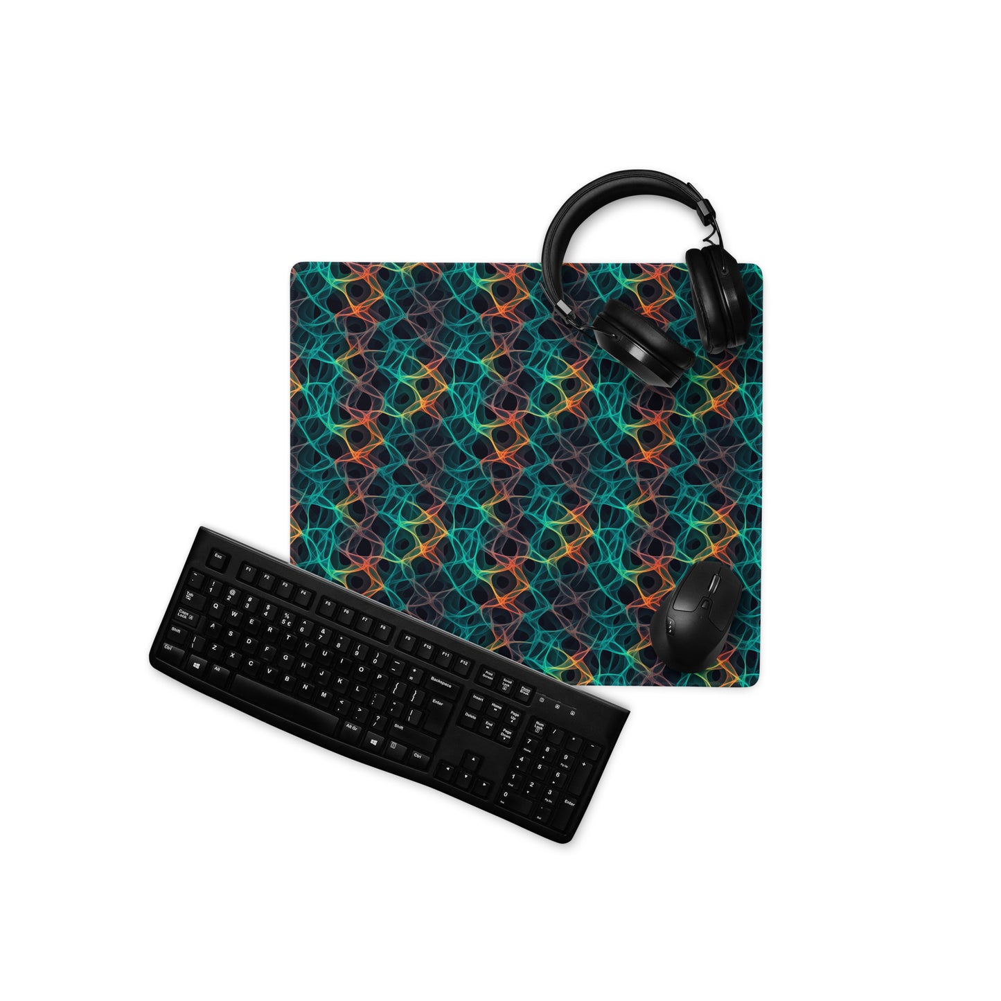 A 18" x 16" desk pad with an abstract pattern resembling a cell structure on it displayed with a keyboard, headphones and a mouse. Rainbow in color.