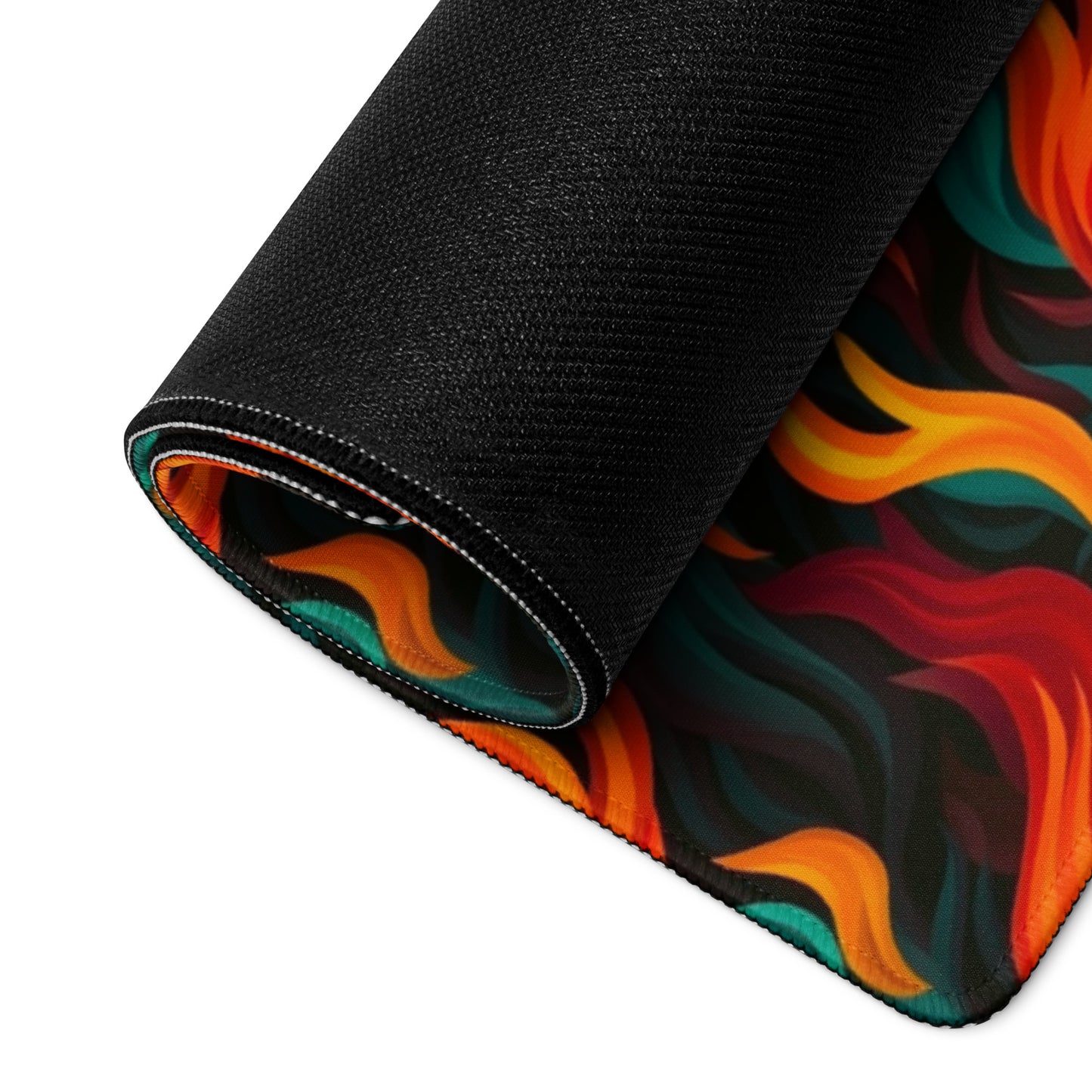 A 36" x 18" desk pad with a wavy flame pattern on it rolled up. Red and Teal in color.