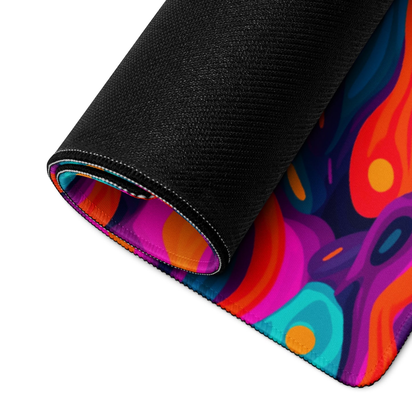 A 36" x 18" desk pad with a wavy abstract pattern on it rolled up. Blue, Purple and Red in color.