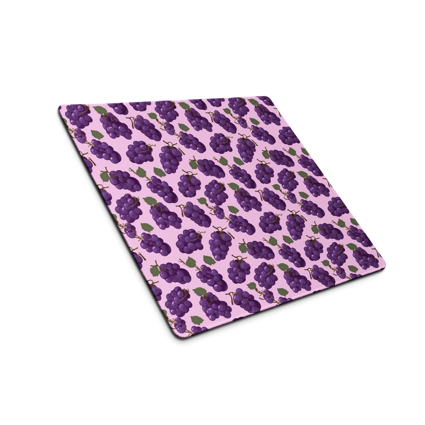 A 18" x 16" desk pad with bushels of grapes all over it shown at an angle. Purple in color.