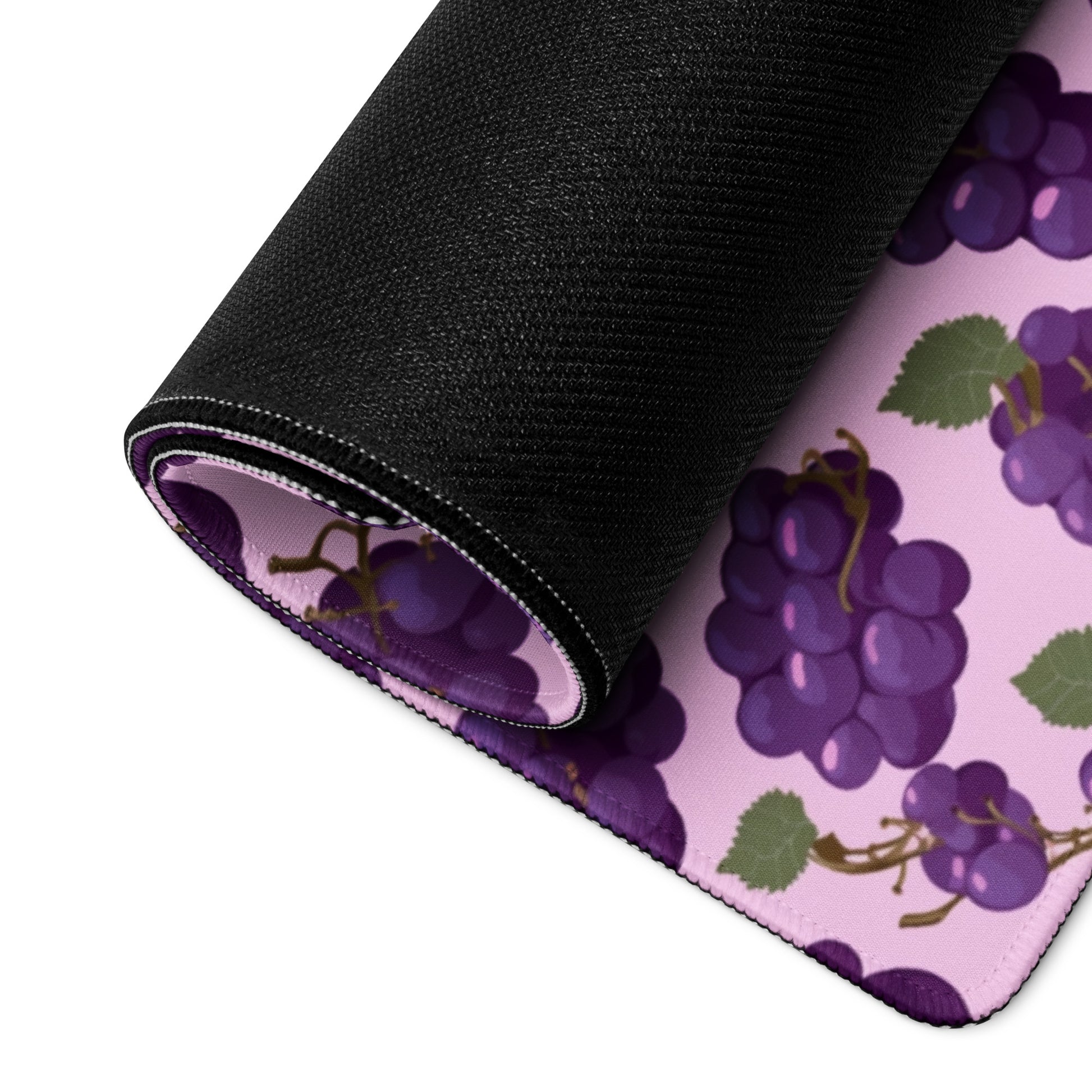 A 36" x 18" desk pad with bushels of grapes all over it rolled up. Purple in color.