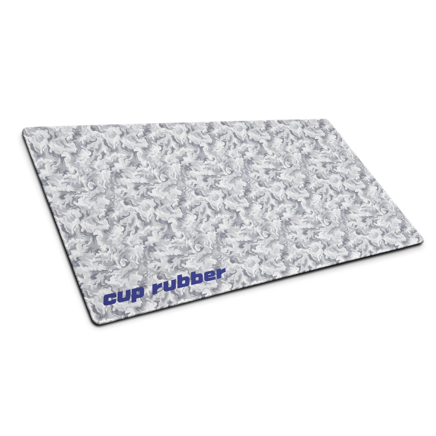 A 36" x 18" desk pad with a camo pattern and the word "Cup Rubber" on it in the bottom left corner shown at an angle. Beige and White in color.