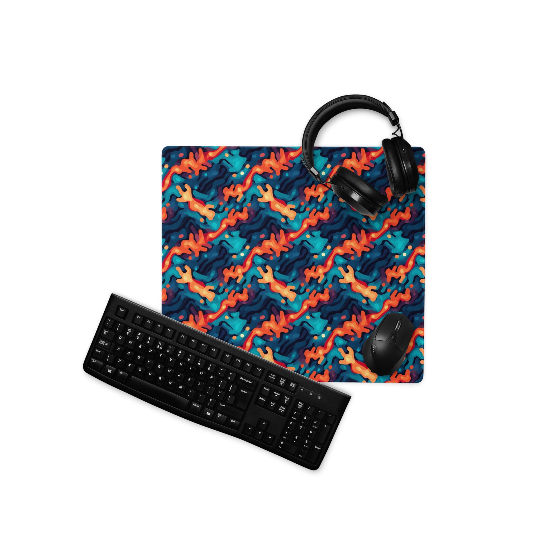 A 18" x 16" desk pad with a wavy woven pattern on it displayed with a keyboard, headphones an a mouse. Red and Blue in color.