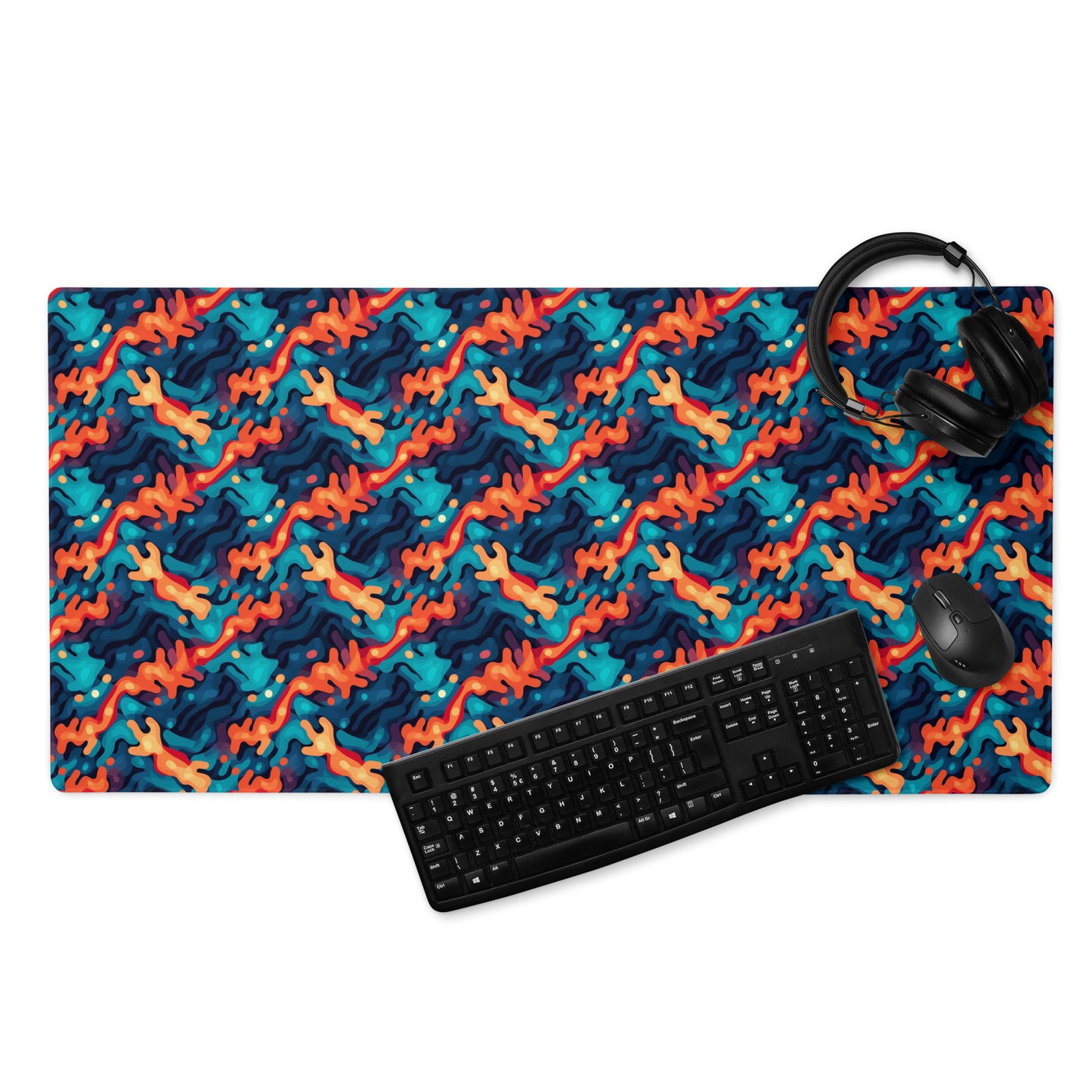 A 36" x 18" desk pad with a wavy woven pattern on it displayed with a keyboard, headphones and a mouse. Red and Blue in color.