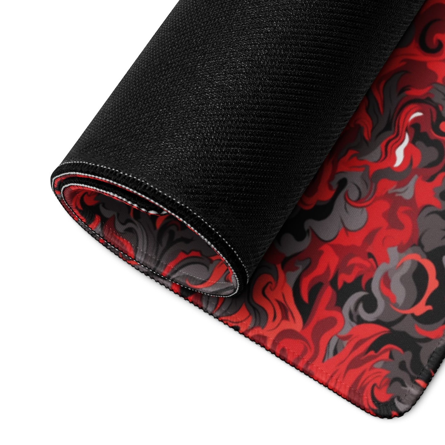 A 36" x 18" desk pad with a black and red camo pattern rolled up.
