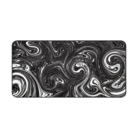 A 31" x 15.5" desk mat with black and white swirls.