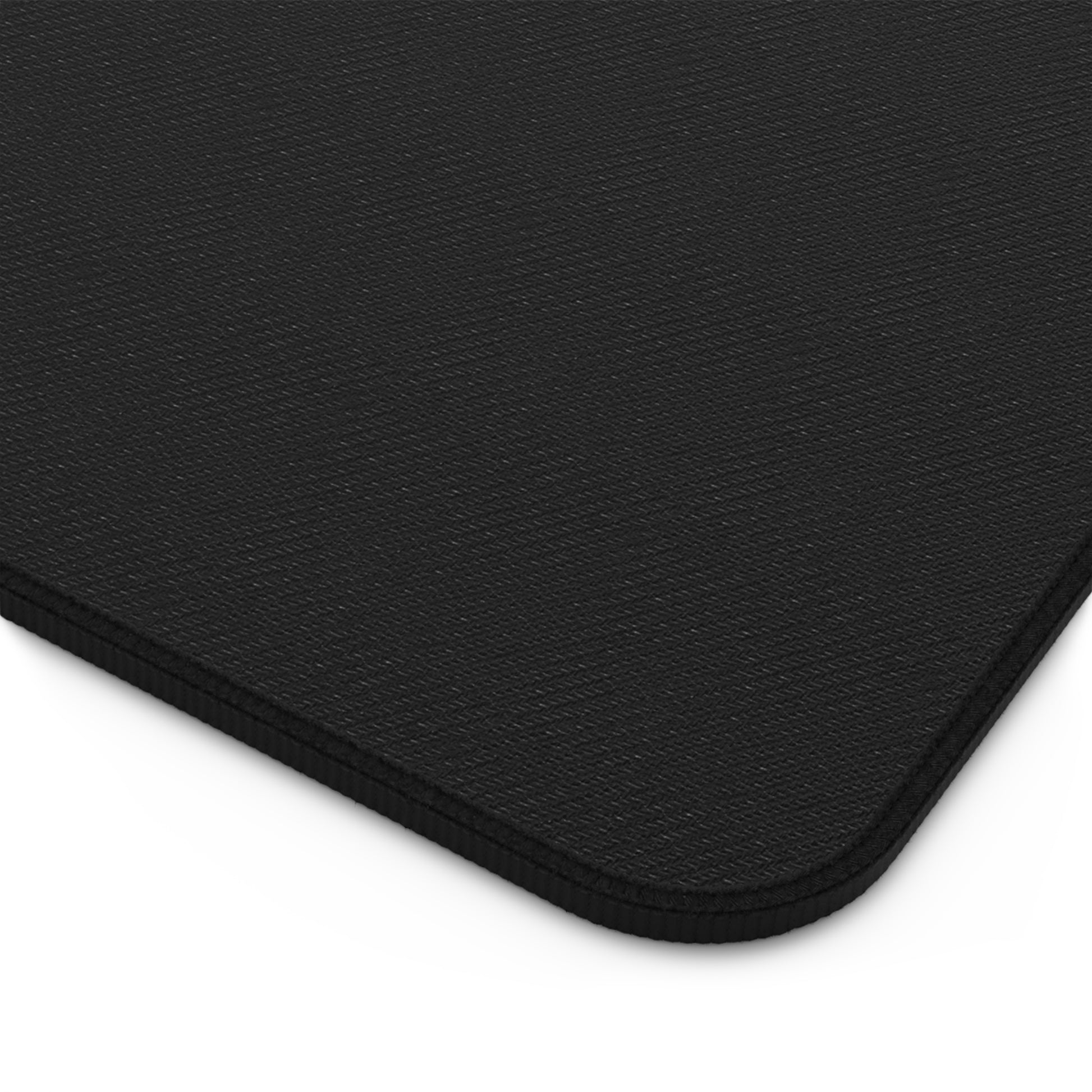 The black rubber bottom of a black and white swirl desk mat.