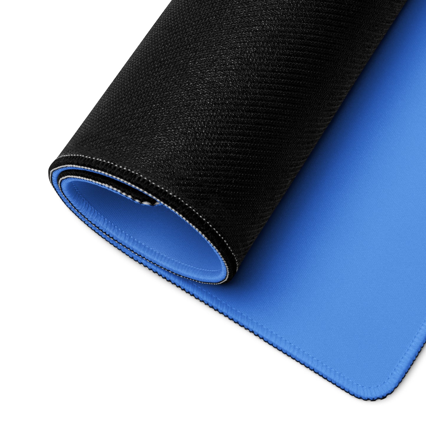 A blue 36" x 18" desk pad with two cowboys dueling rolled up.