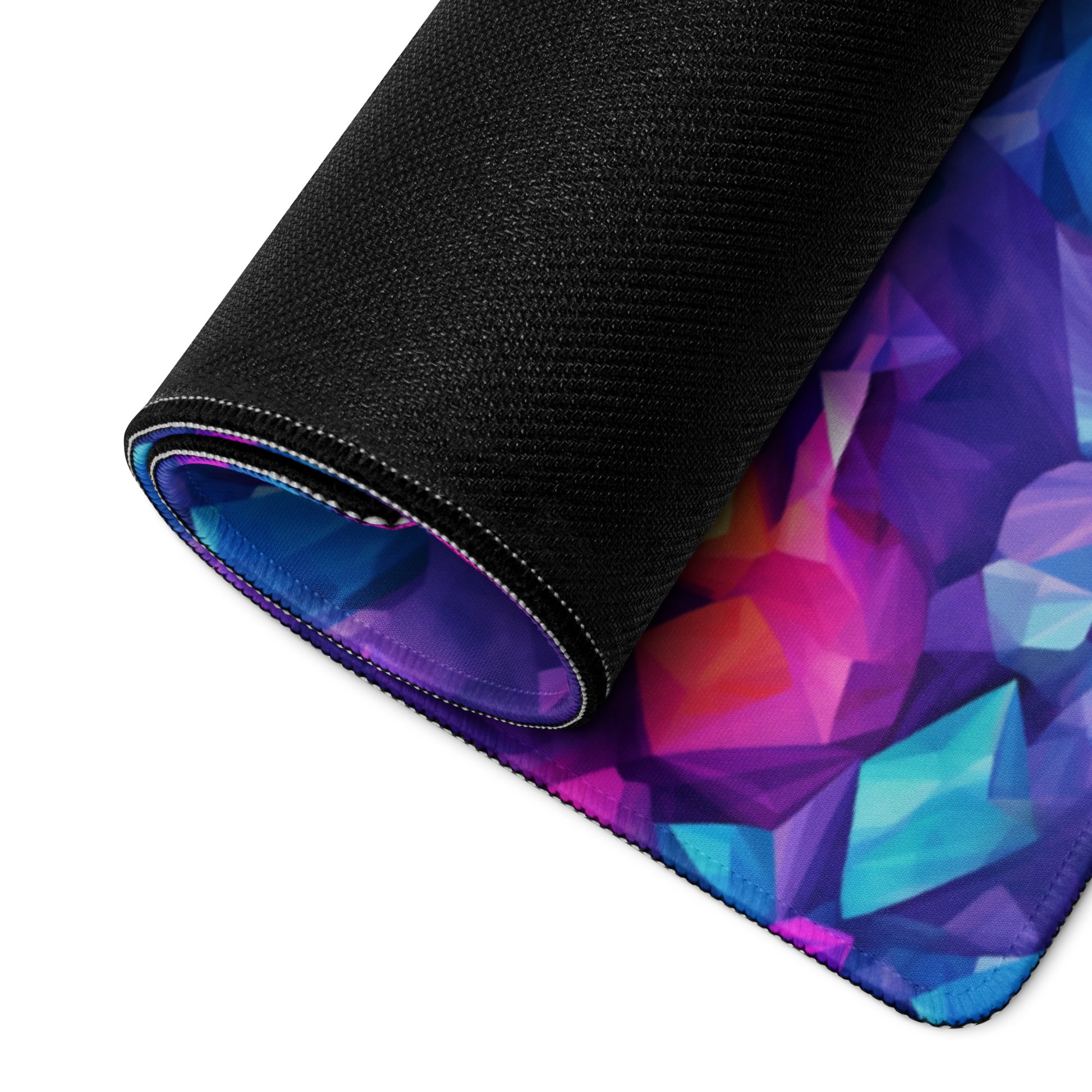 A blue and purple crystal gaming desk pad rolled up.