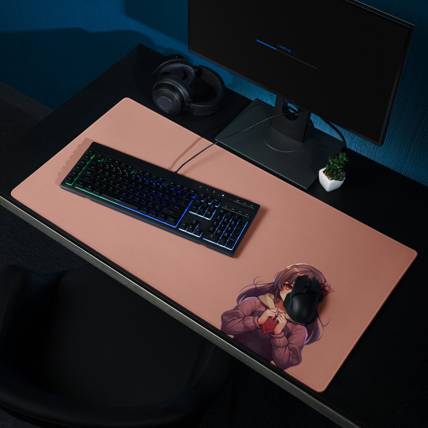 A 36" x 18" gaming desk pad with a blushing anime girl on a rose gold background laying on a desk.