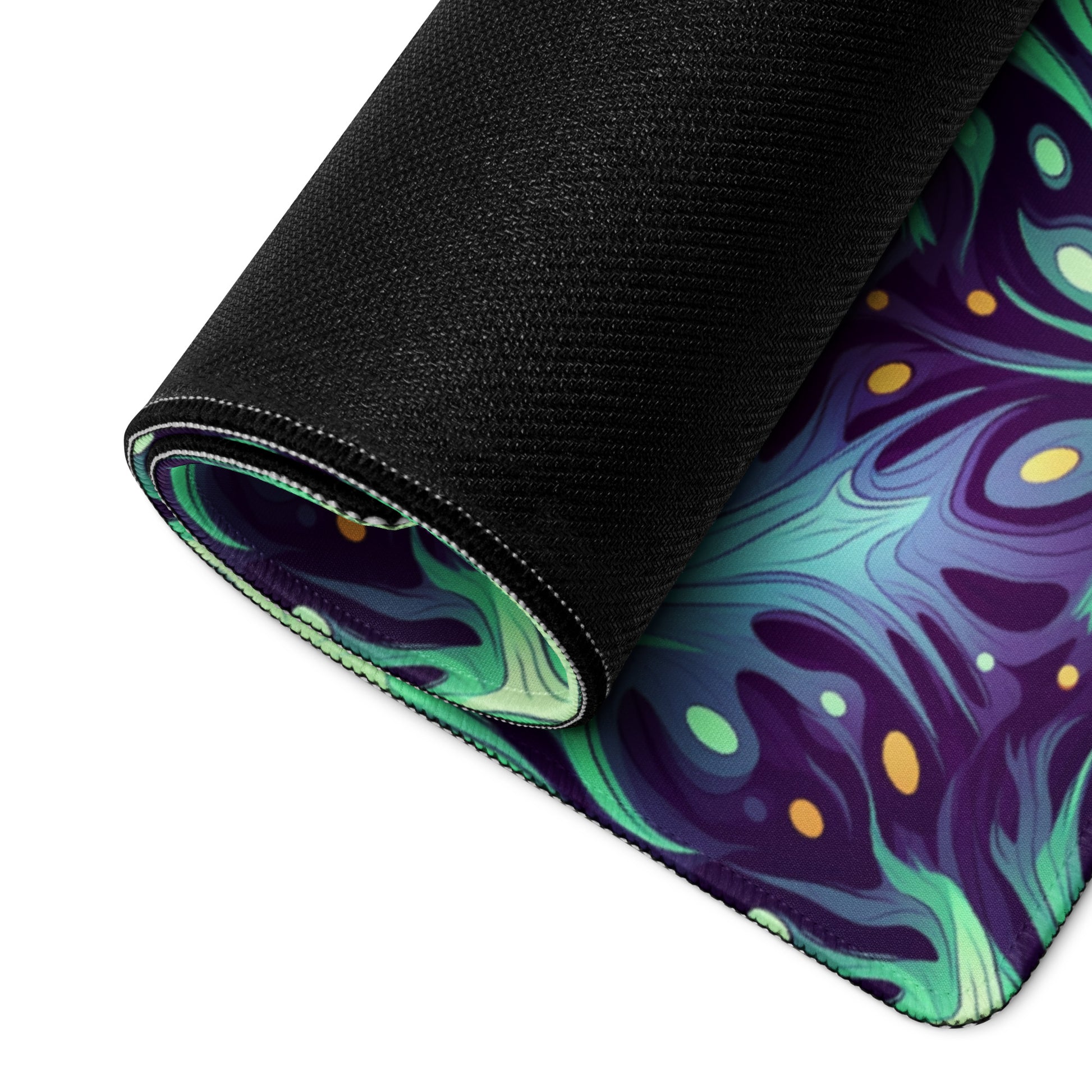 A 36" x 18" desk pad with a green and blue abstract pattern rolled up.