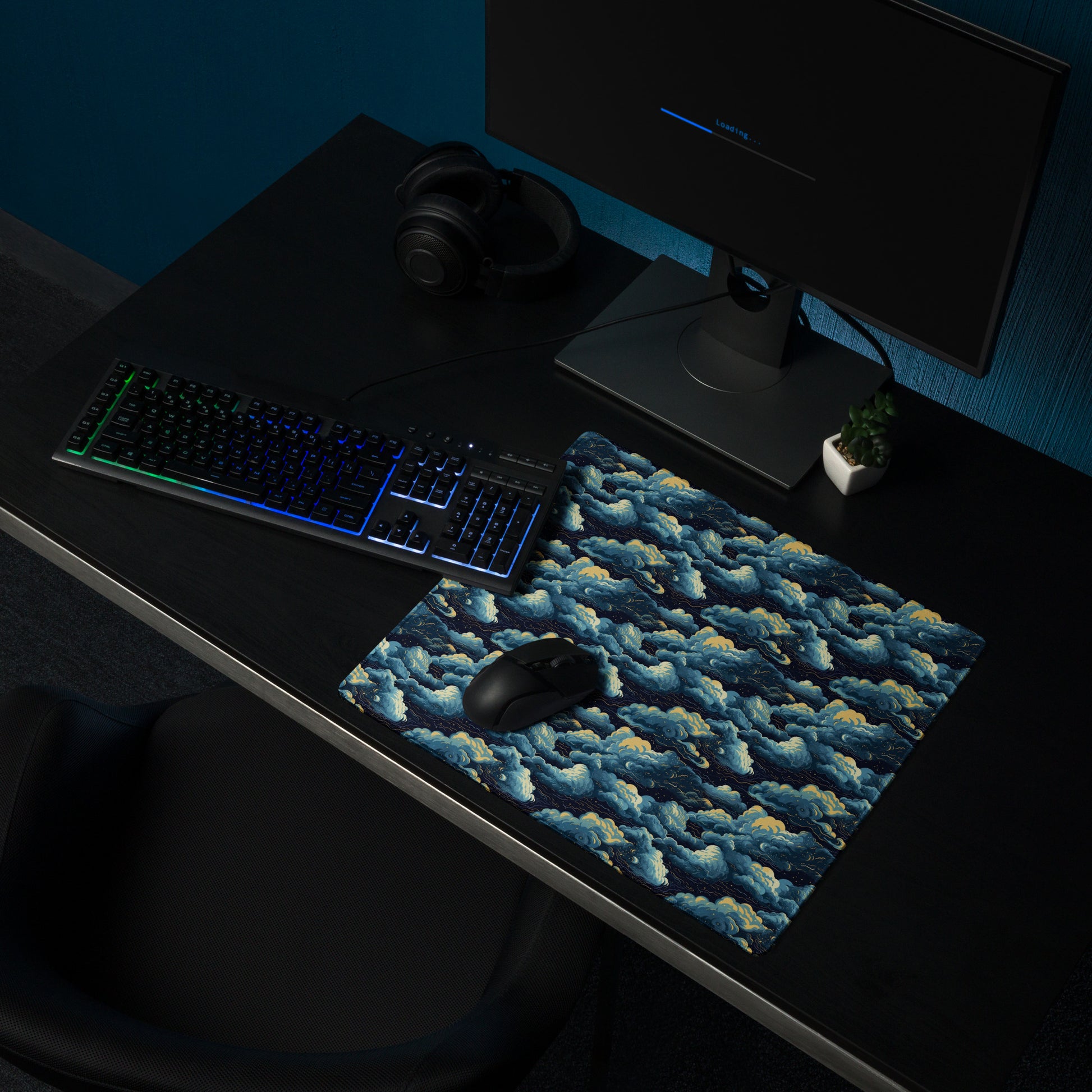 A 18" x 16" desk pad with a cloudy night sky pattern sitting on a desk.