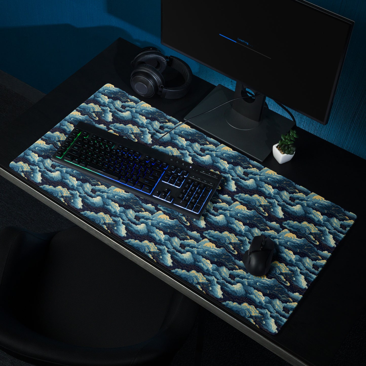 A 36" x 18" desk pad with a cloudy night sky pattern sitting on a desk.