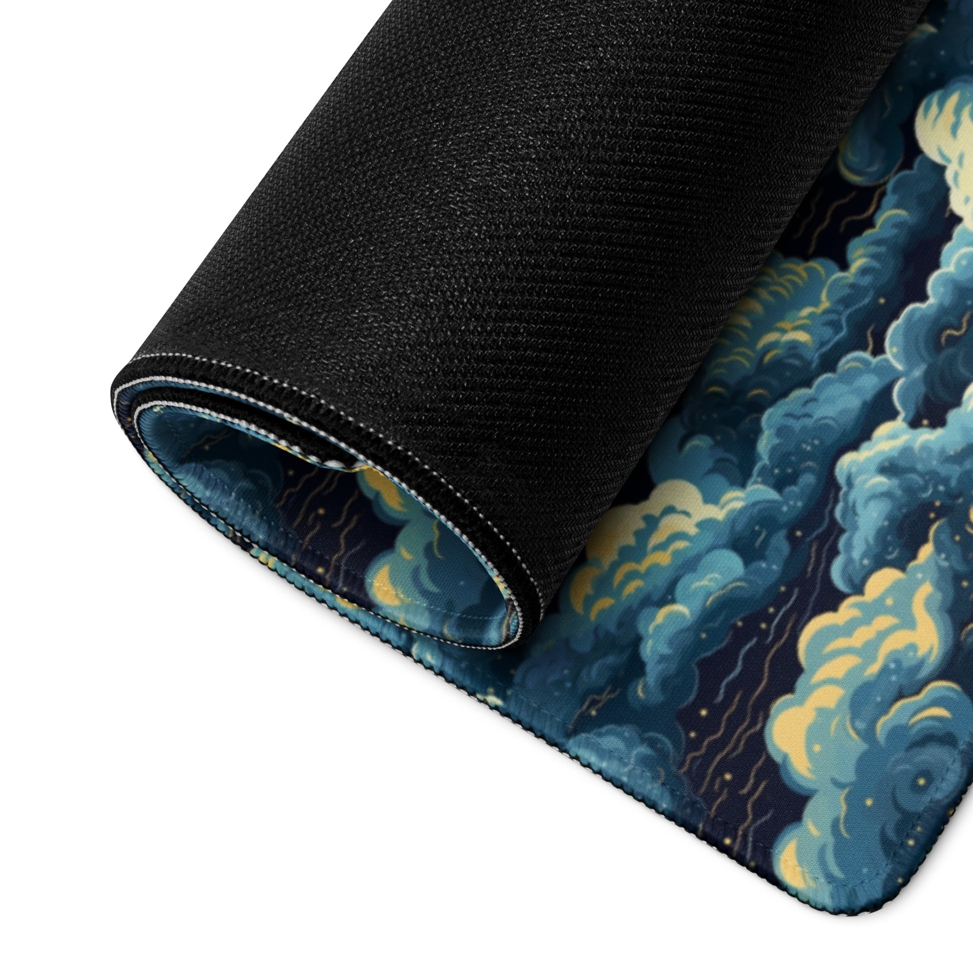 A 36" x 18" desk pad with a cloudy night sky pattern rolled up.