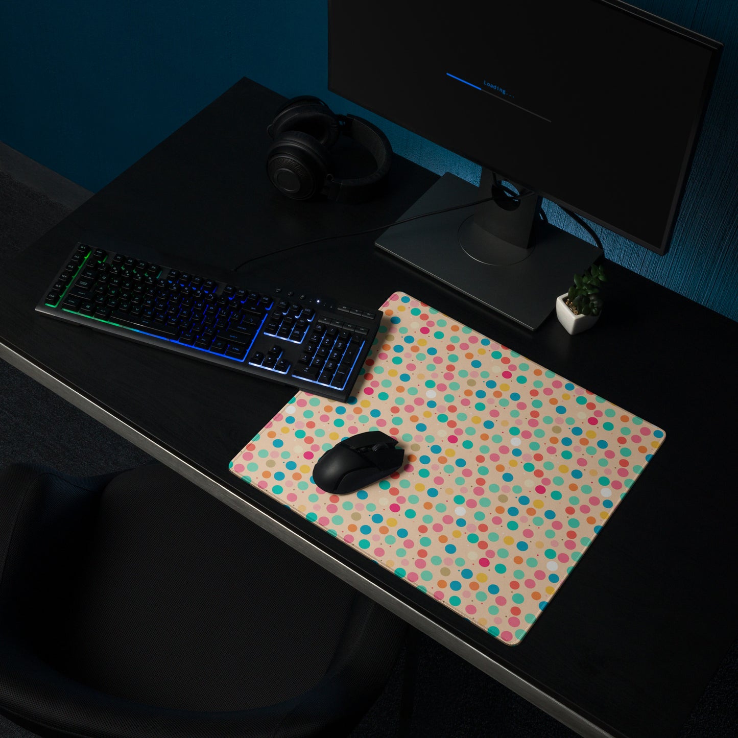 A 18" x 16" desk pad with a colorful polka dot pattern sitting on a desk.
