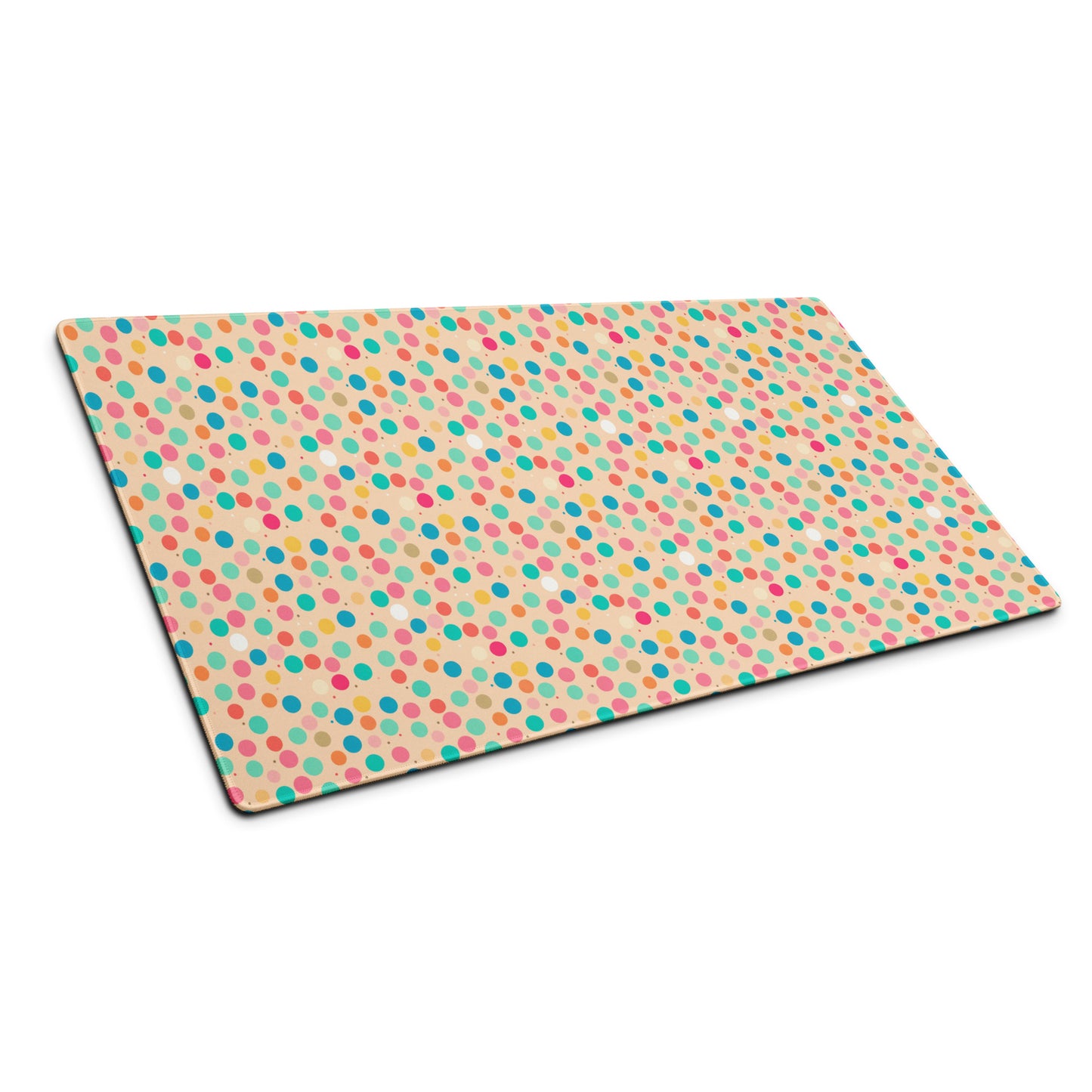 A 36" x 18" desk pad with a colorful polka dot pattern sitting at an angle.