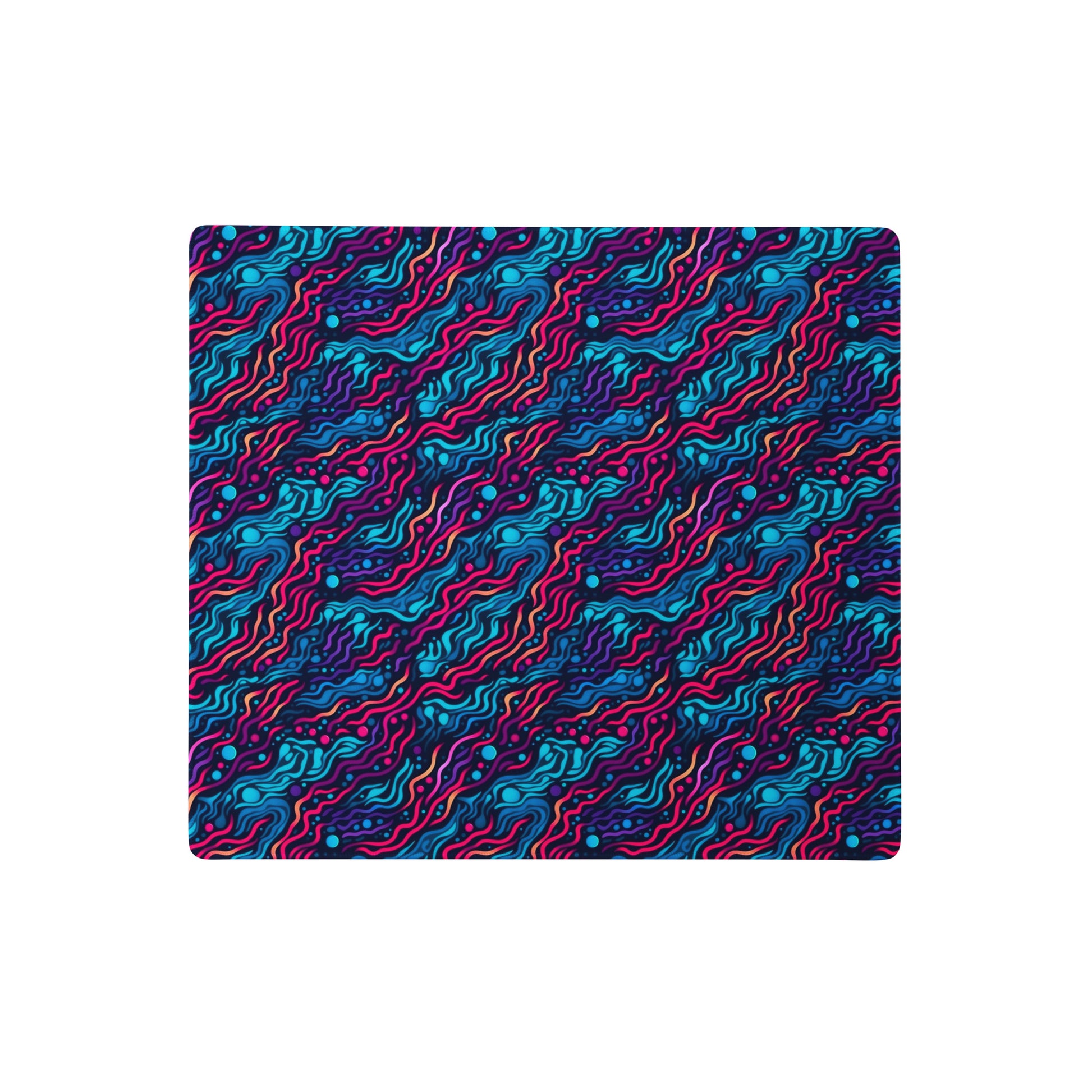 A 18" x 16" desk pad with wavy blue and pink pattern.