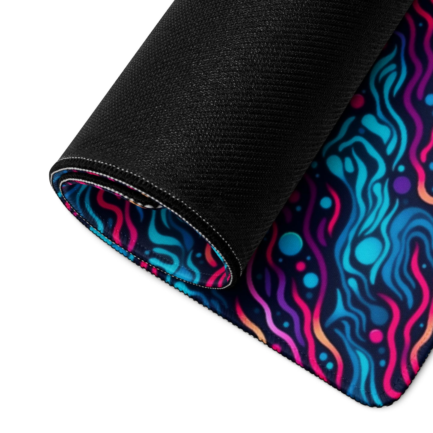 A 36" x 18" desk pad with wavy blue and pink pattern rolled up.