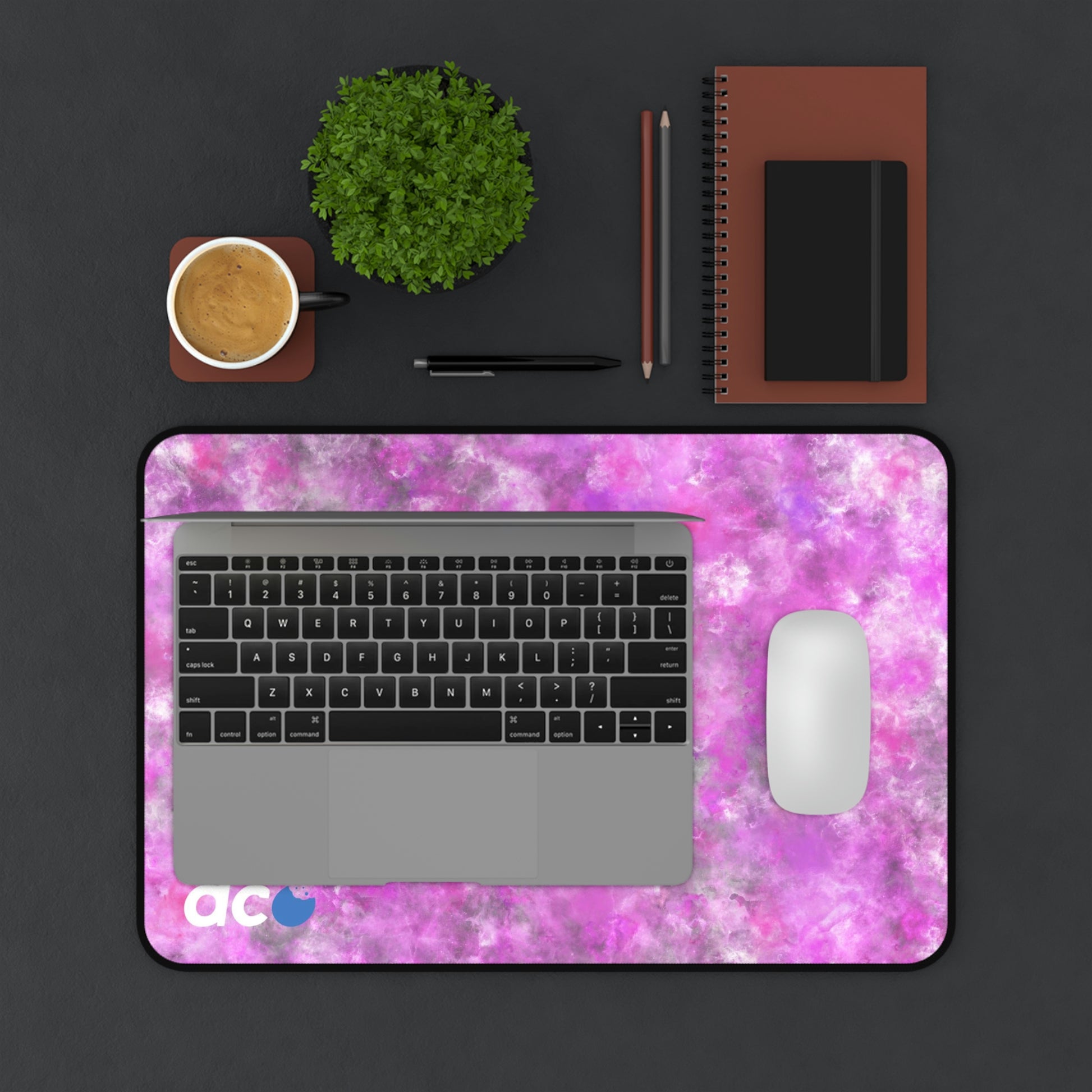 A 12" x 18" desk mat with a fluffy mix of pink, white, and gray. A laptop and mouse sit on top of it.