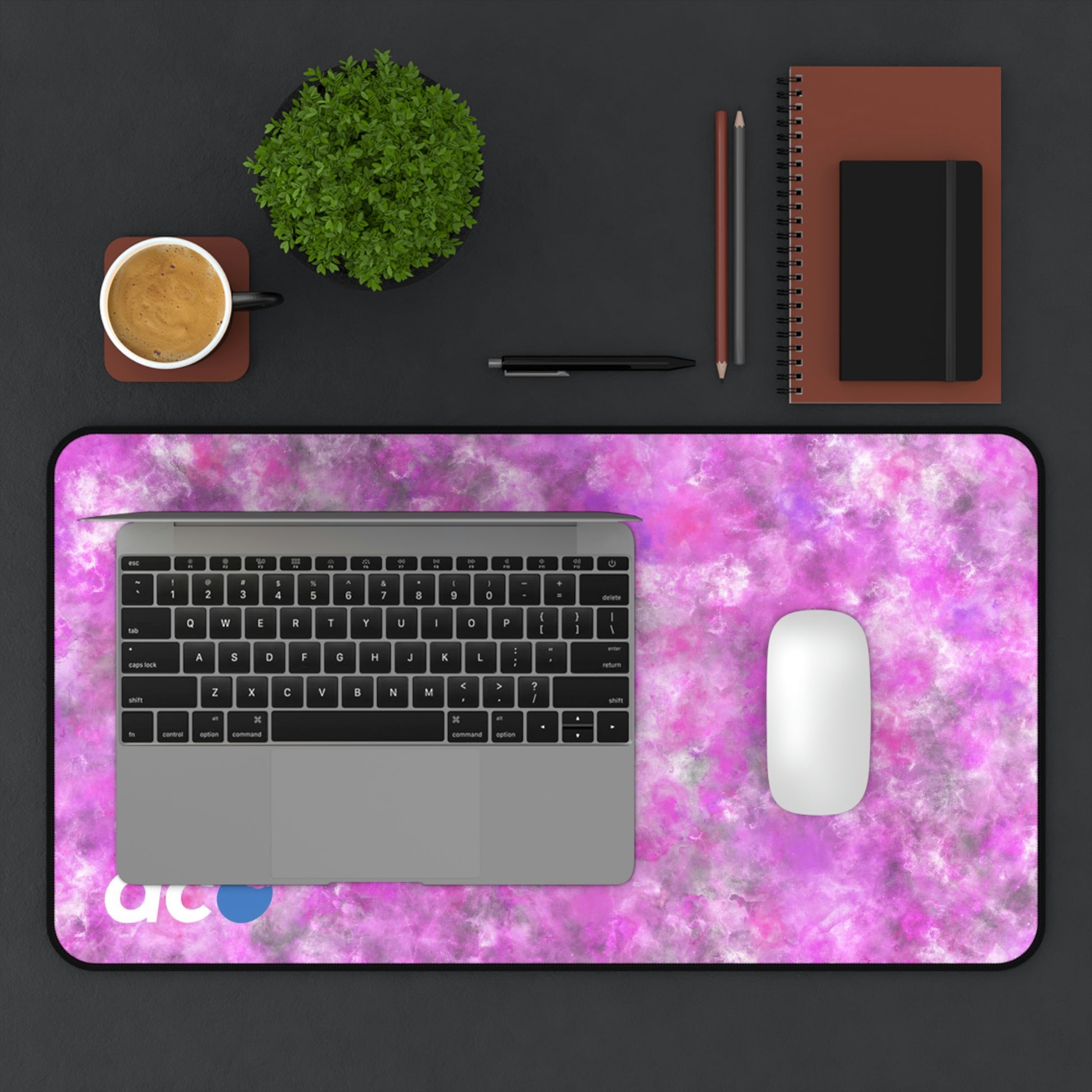 A 12" x 22" desk mat with a fluffy mix of pink, white, and gray. A laptop and mouse sit on top of it.