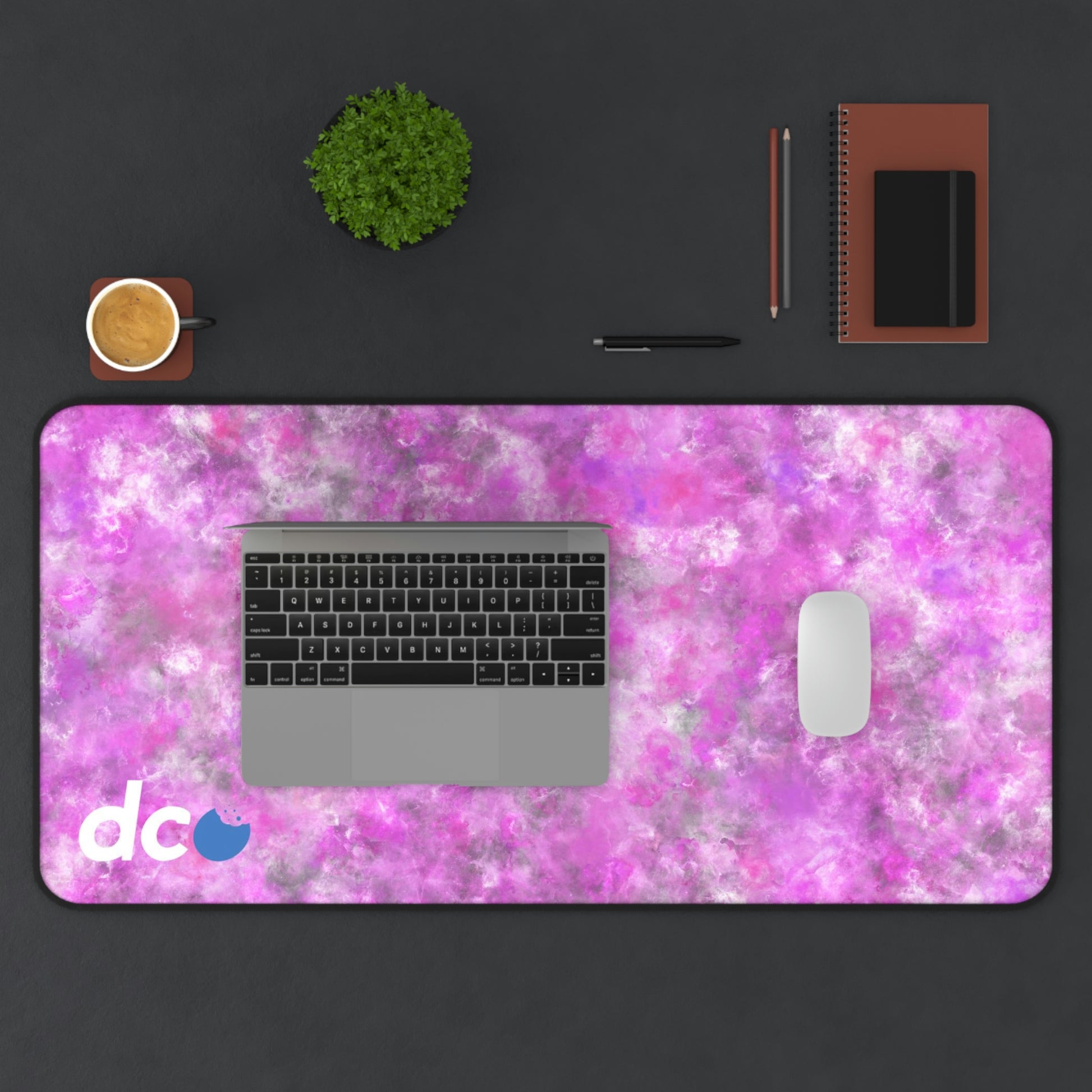 A 31" x 15.5" desk mat with a fluffy mix of pink, white, and gray. A laptop and mouse sit on top of it.