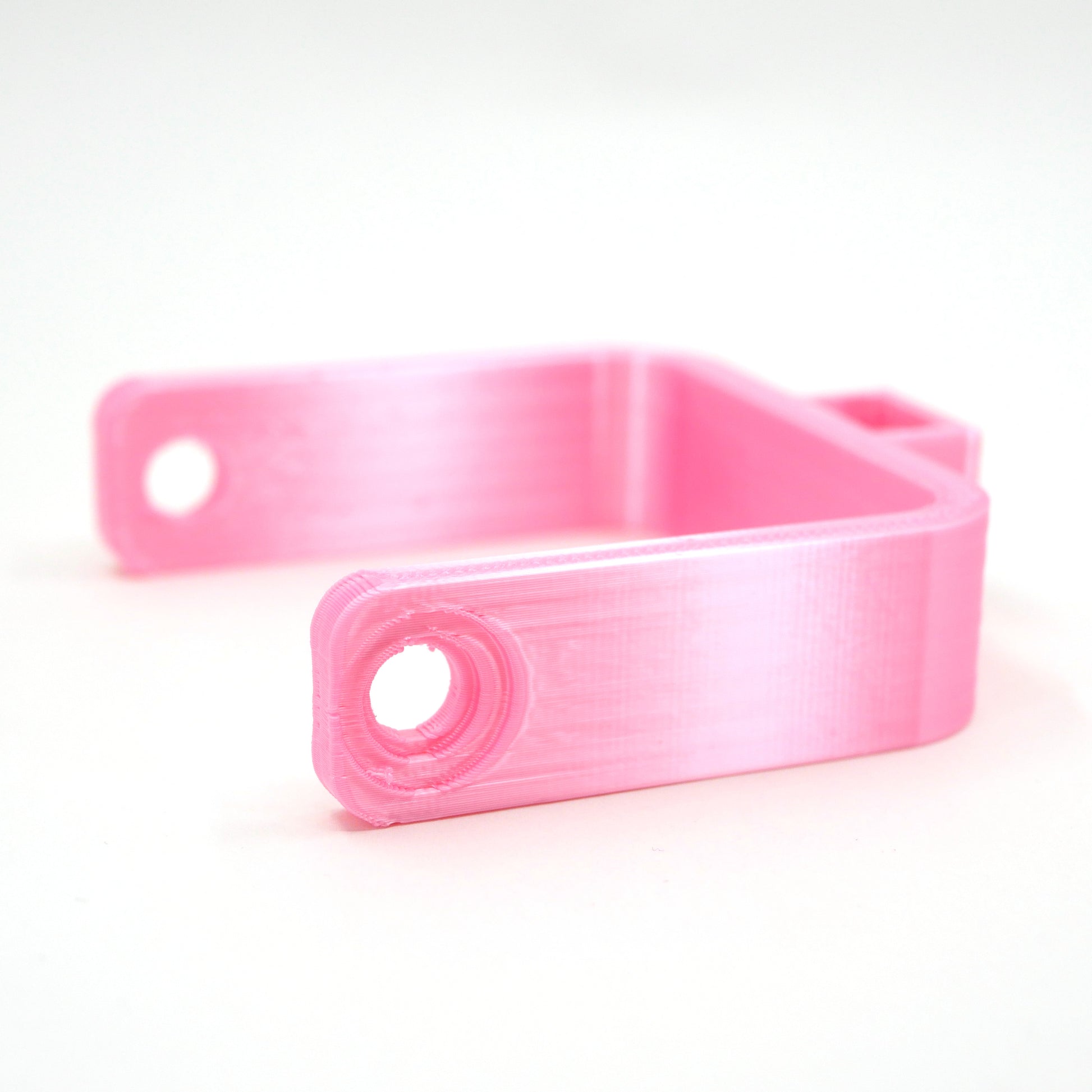 A pink microphone mount for the Elgato Wave microphone.