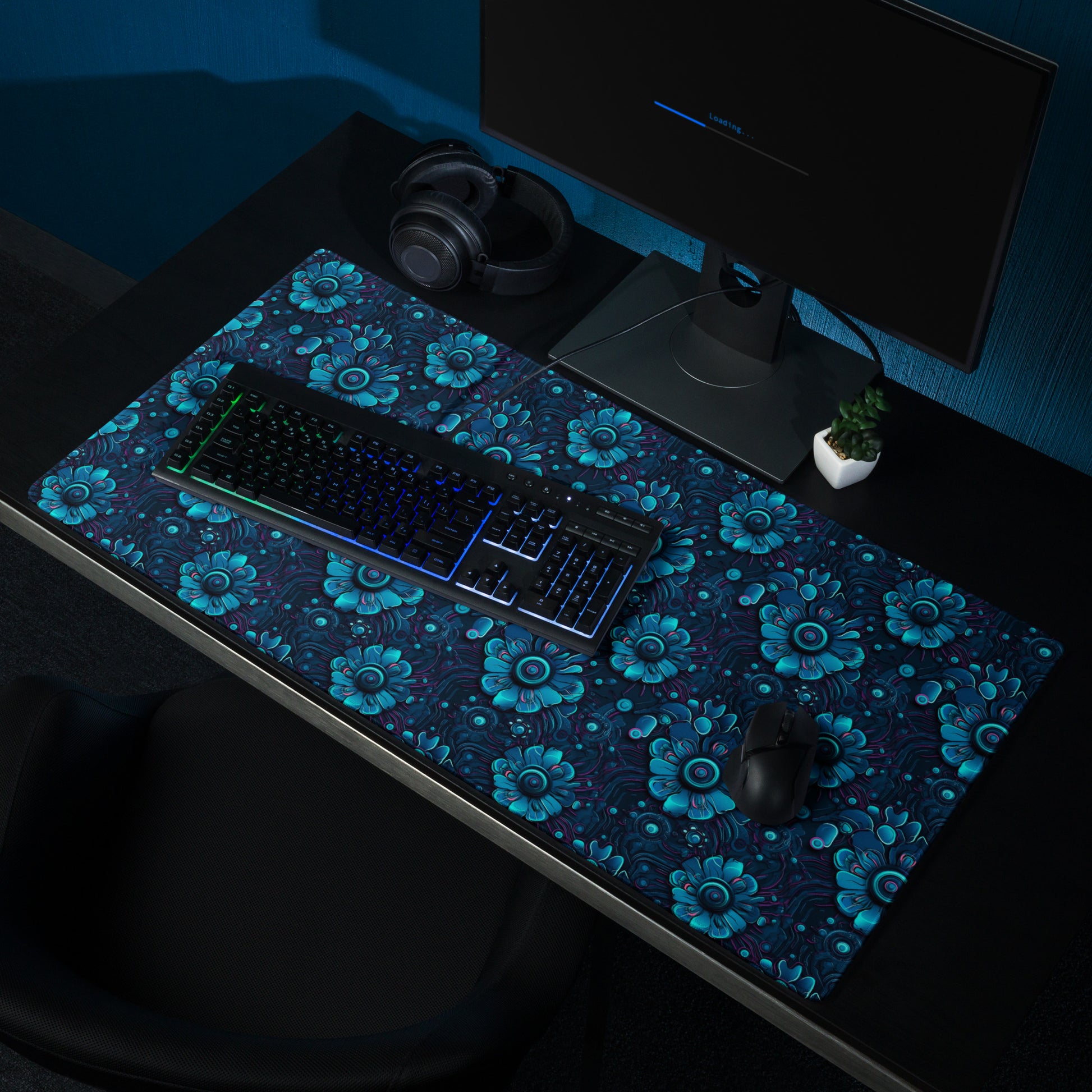 A 36" x 18" desk pad with a blue robotic floral pattern sitting on a desk.