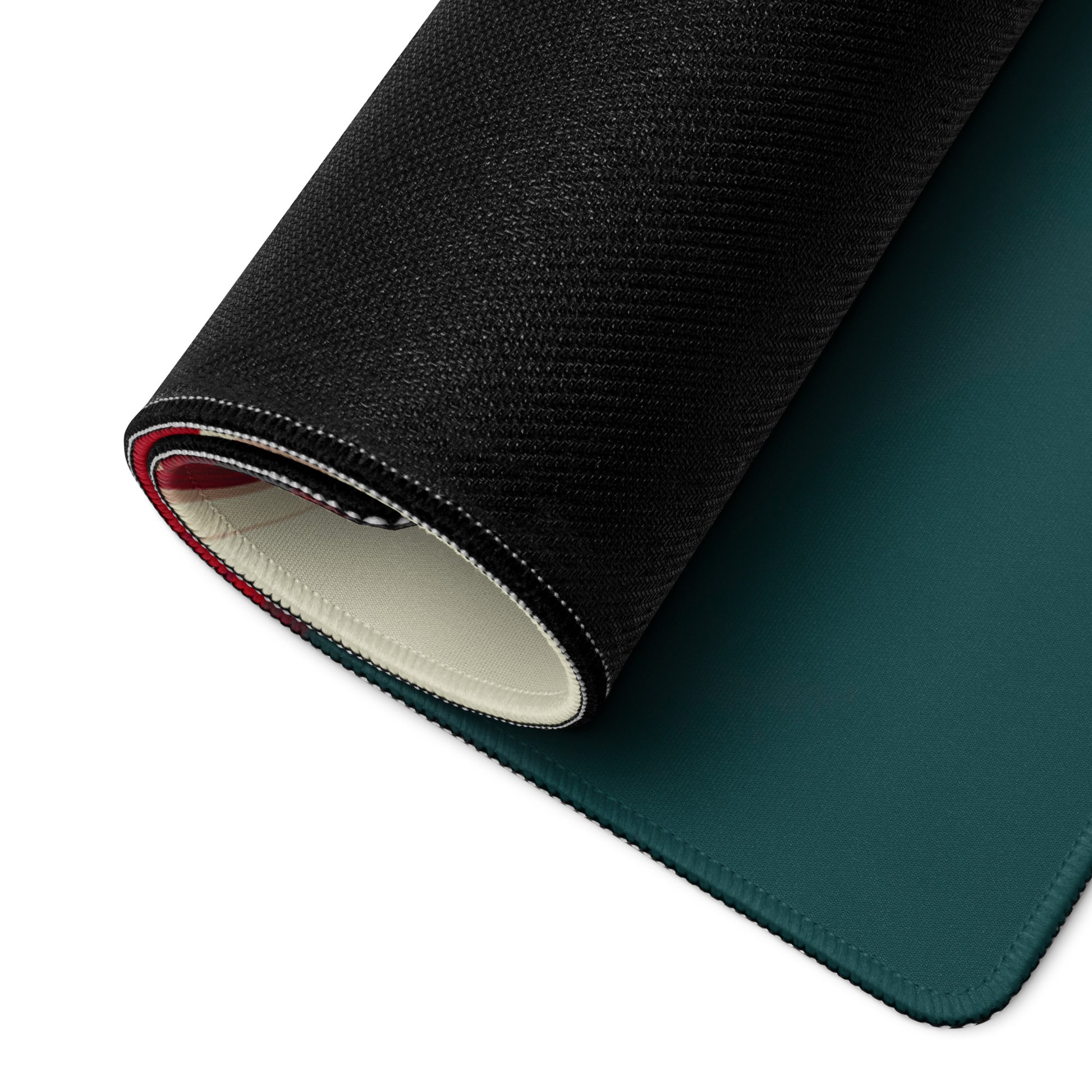 A 36" x 18" teal, red, and white desk pad with a formula one car on the right rolled up.