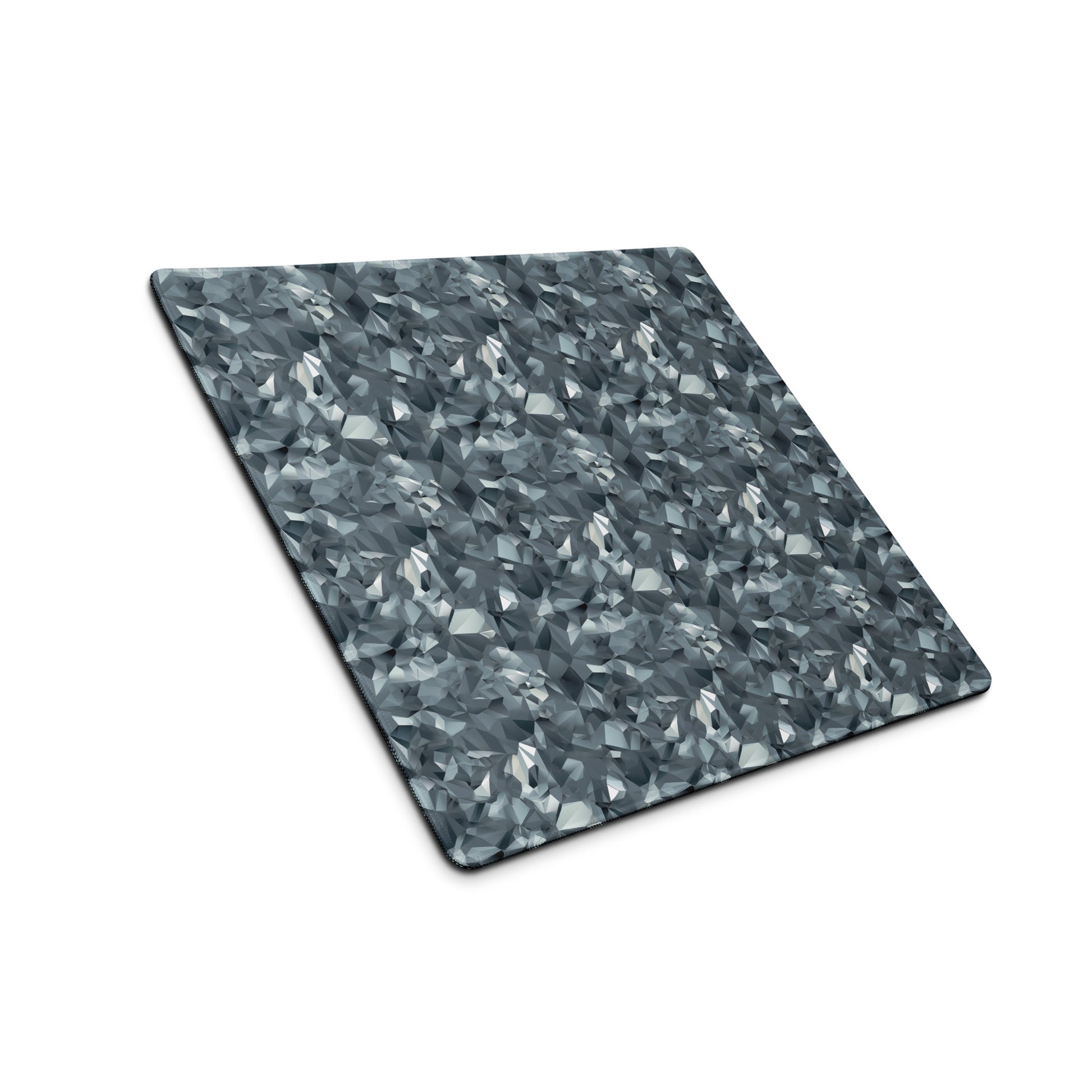 An 18" x 16" gaming desk pad with gray crystals sitting at an angle.