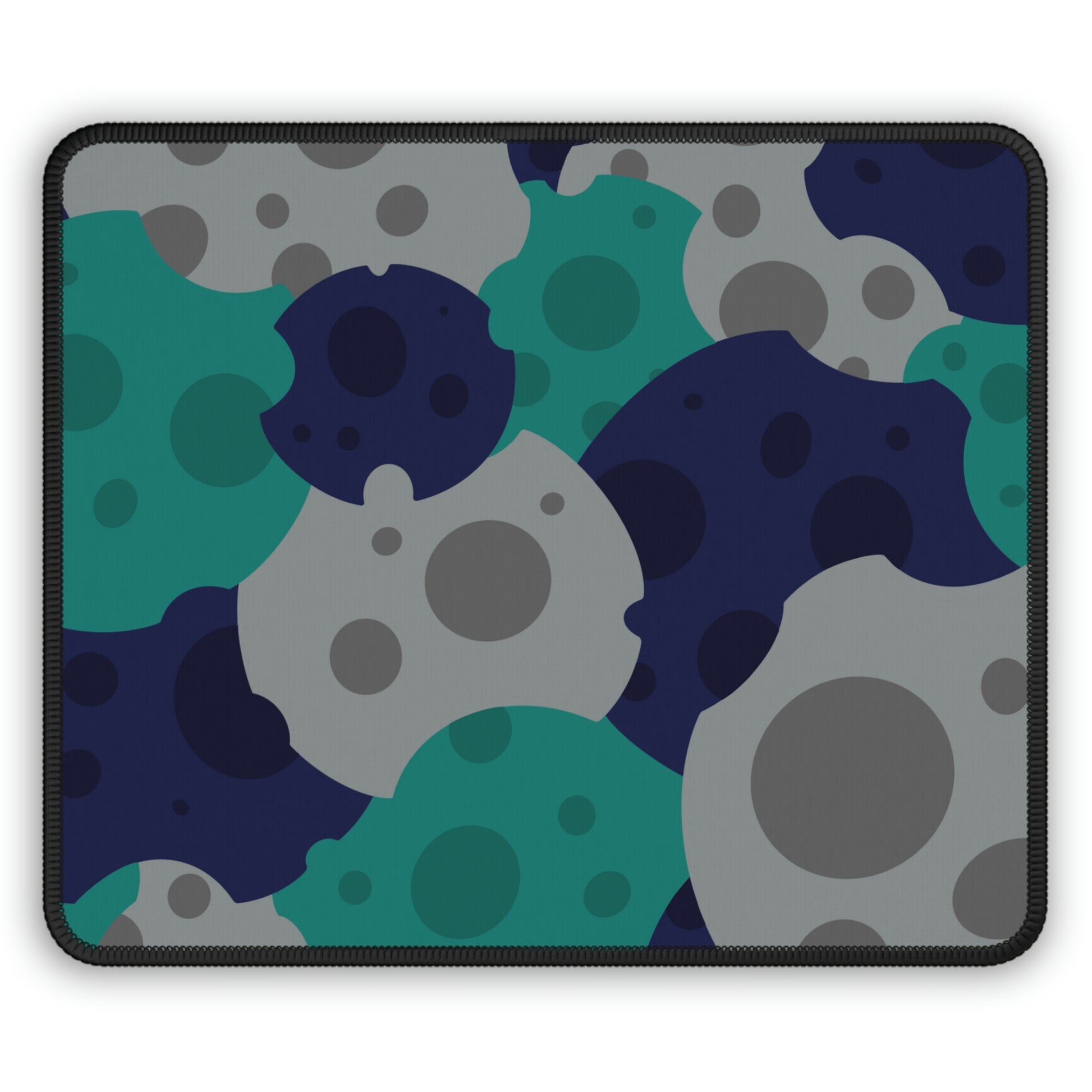 A gaming mouse pad with gray, teal, and dark blue meteorites.