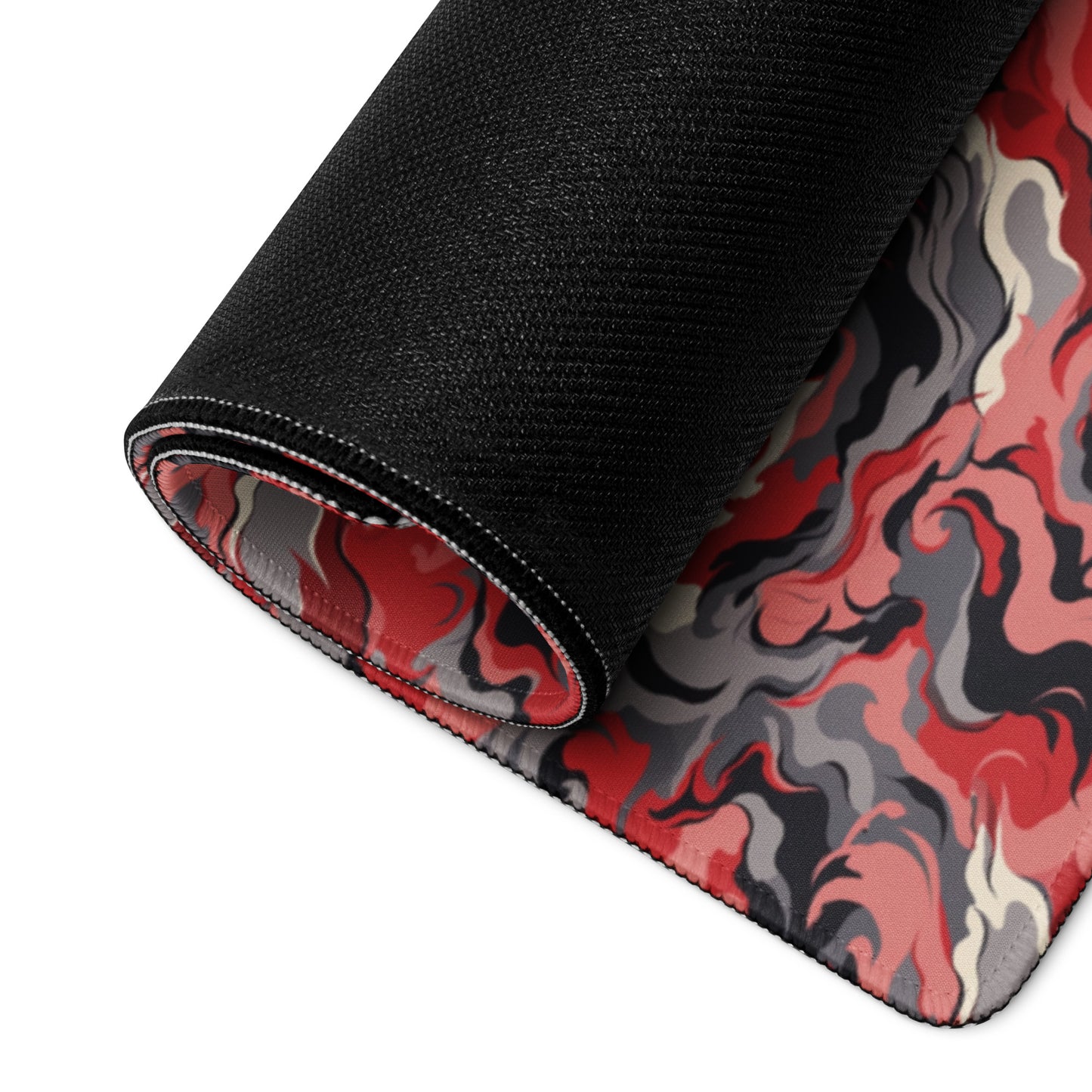A 36" x 18" desk pad with a grey and red camo pattern rolled up.