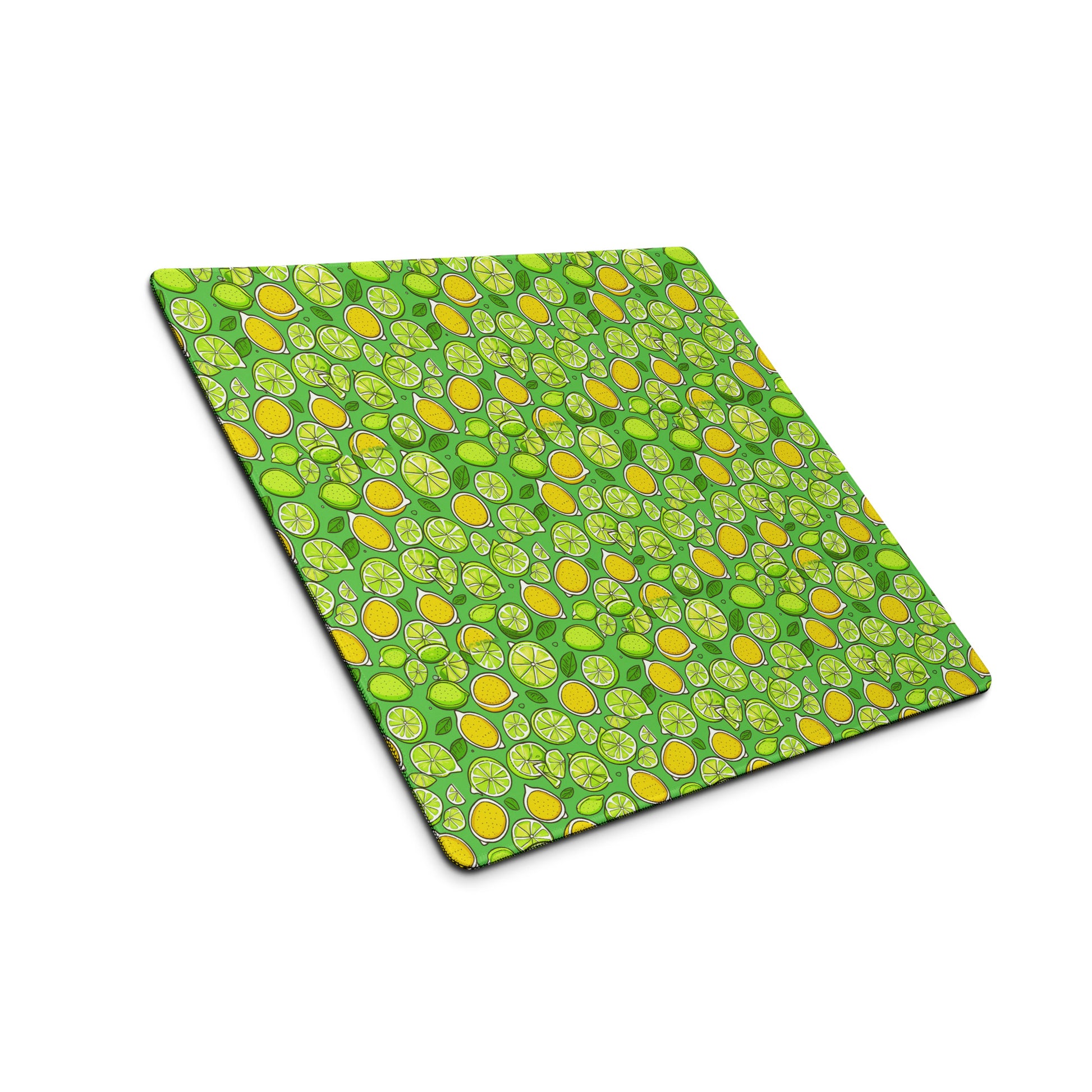 An 18" x 16" gaming desk pad with lemons and limes on a green background sitting at an angle.