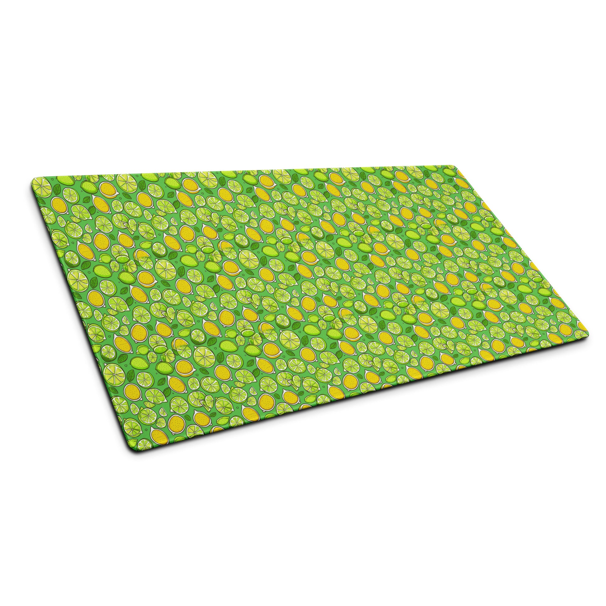 A 36" x 18" gaming desk pad with lemons and limes on a green background sitting at an angle.