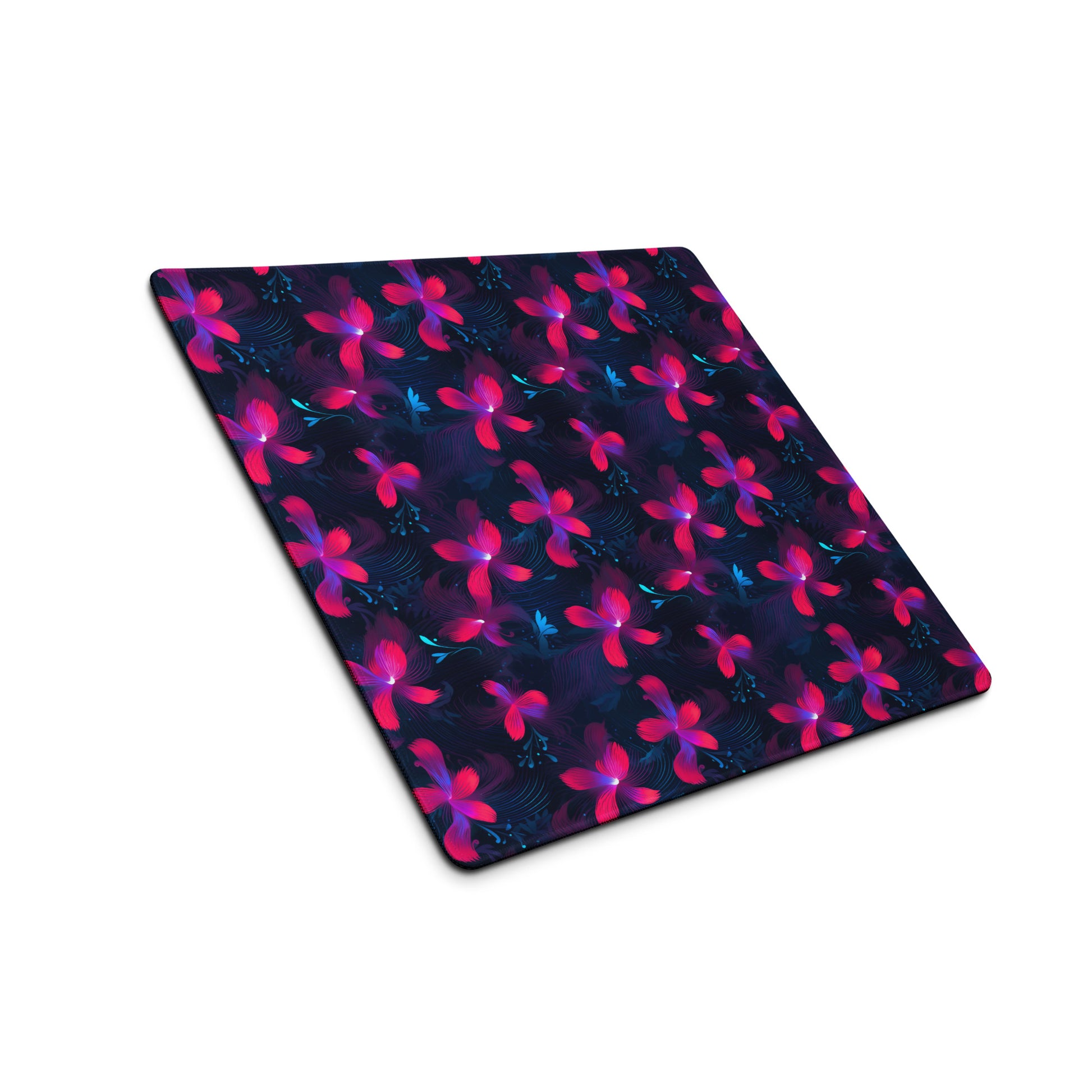 A 18" x 16" desk pad with neon pink and blue floral pattern sitting at an angle.