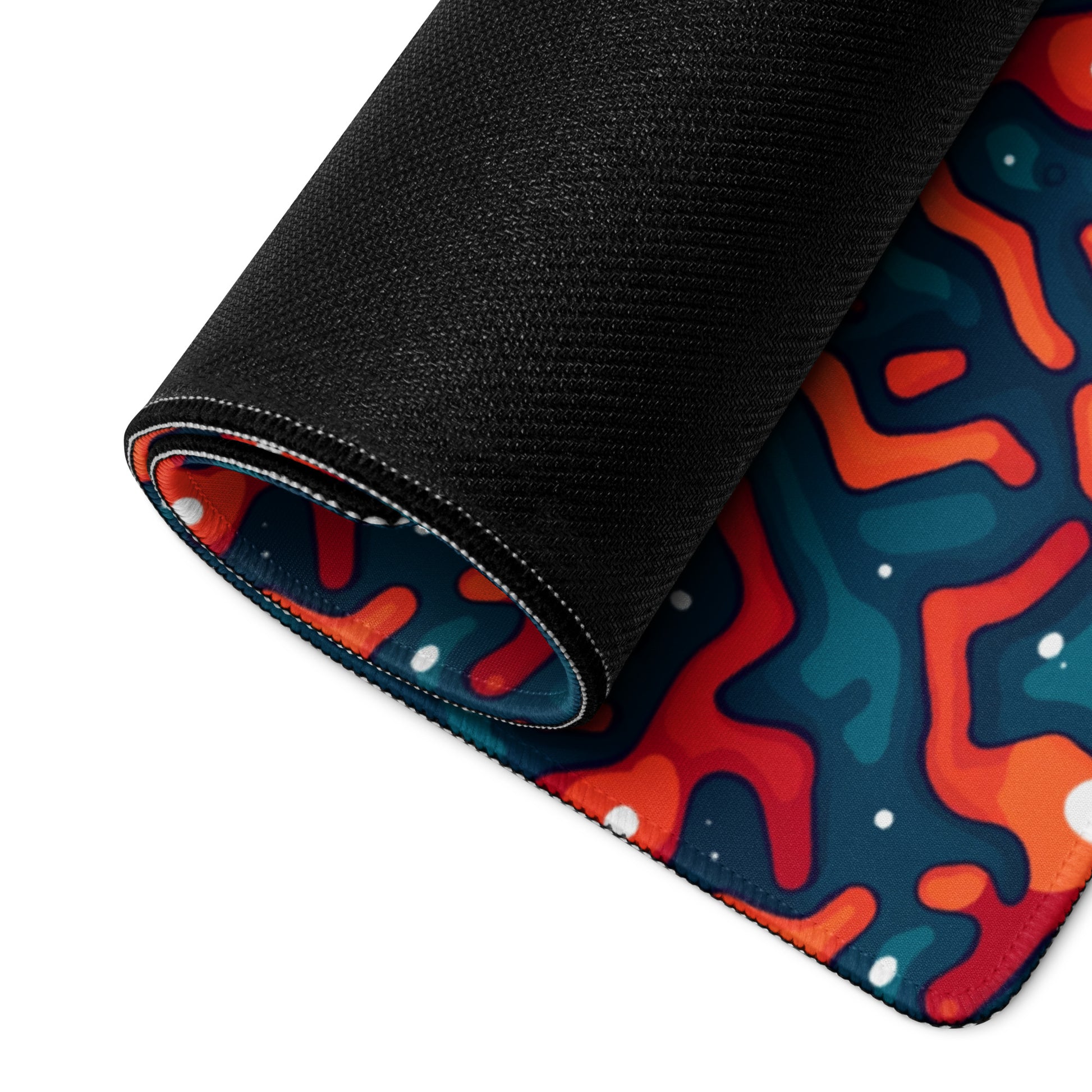 A 36" x 18" desk pad with a blue and orange crack pattern rolled up.