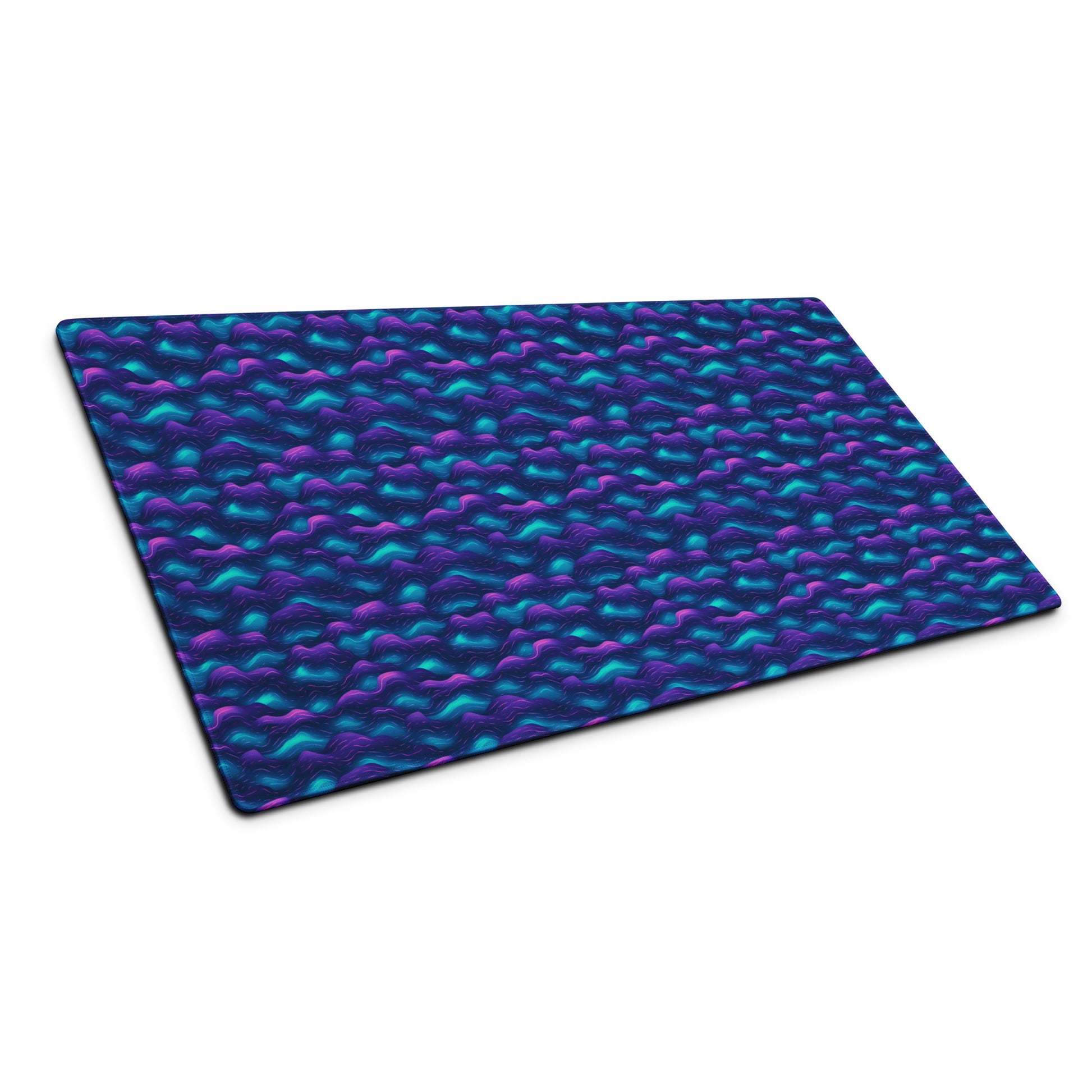 A 36" x 18" desk pad with blue and purple wave pattern sitting at an angle.