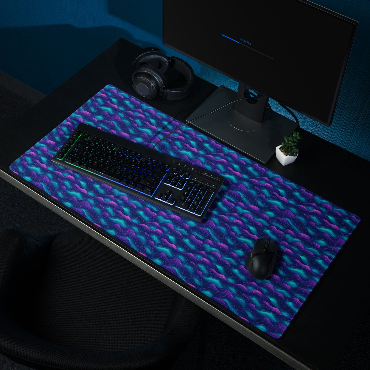 A 36" x 18" desk pad with blue and purple wave pattern sitting on a desk.