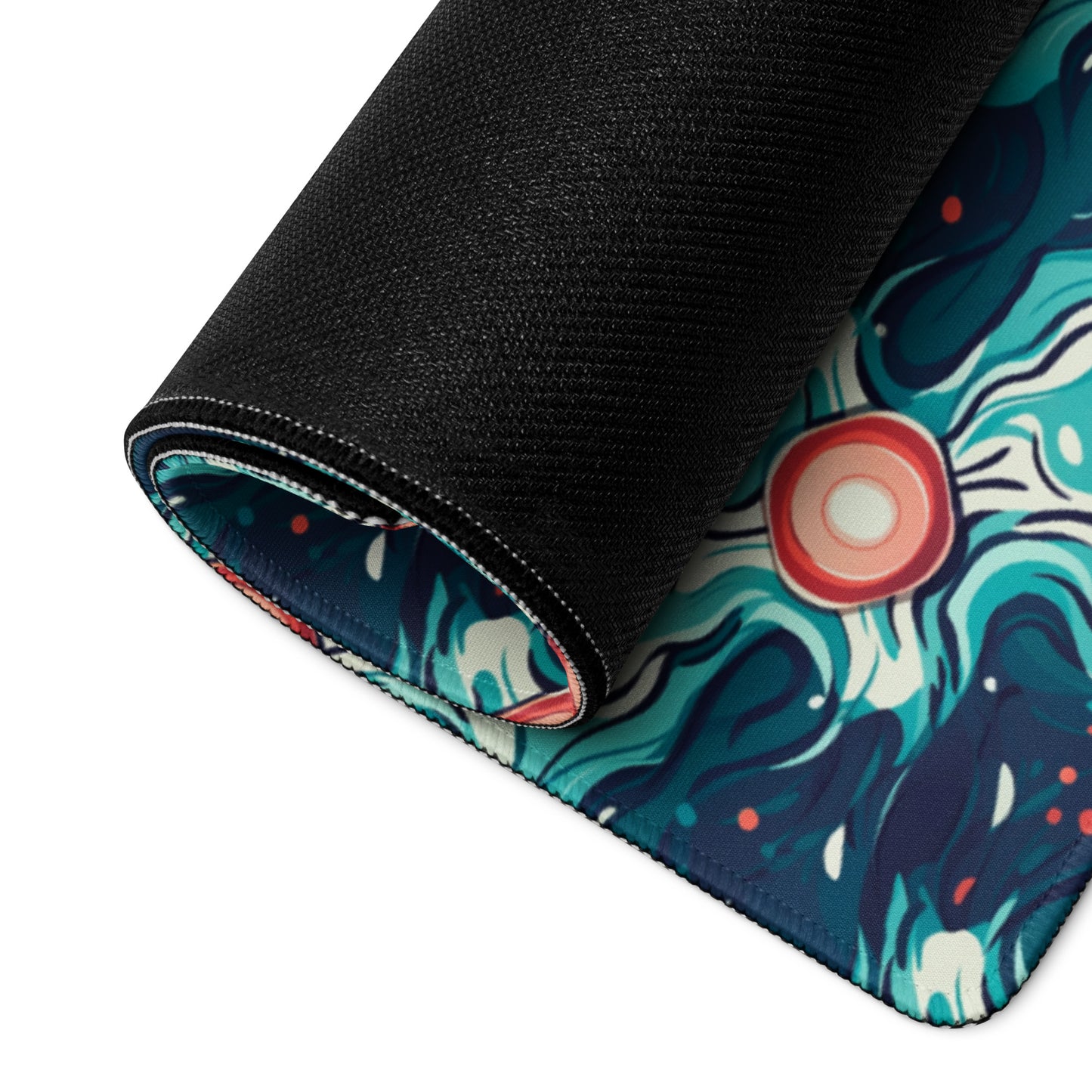 A 36" x 18" desk pad with a teal abstract wavy pattern rolled up.