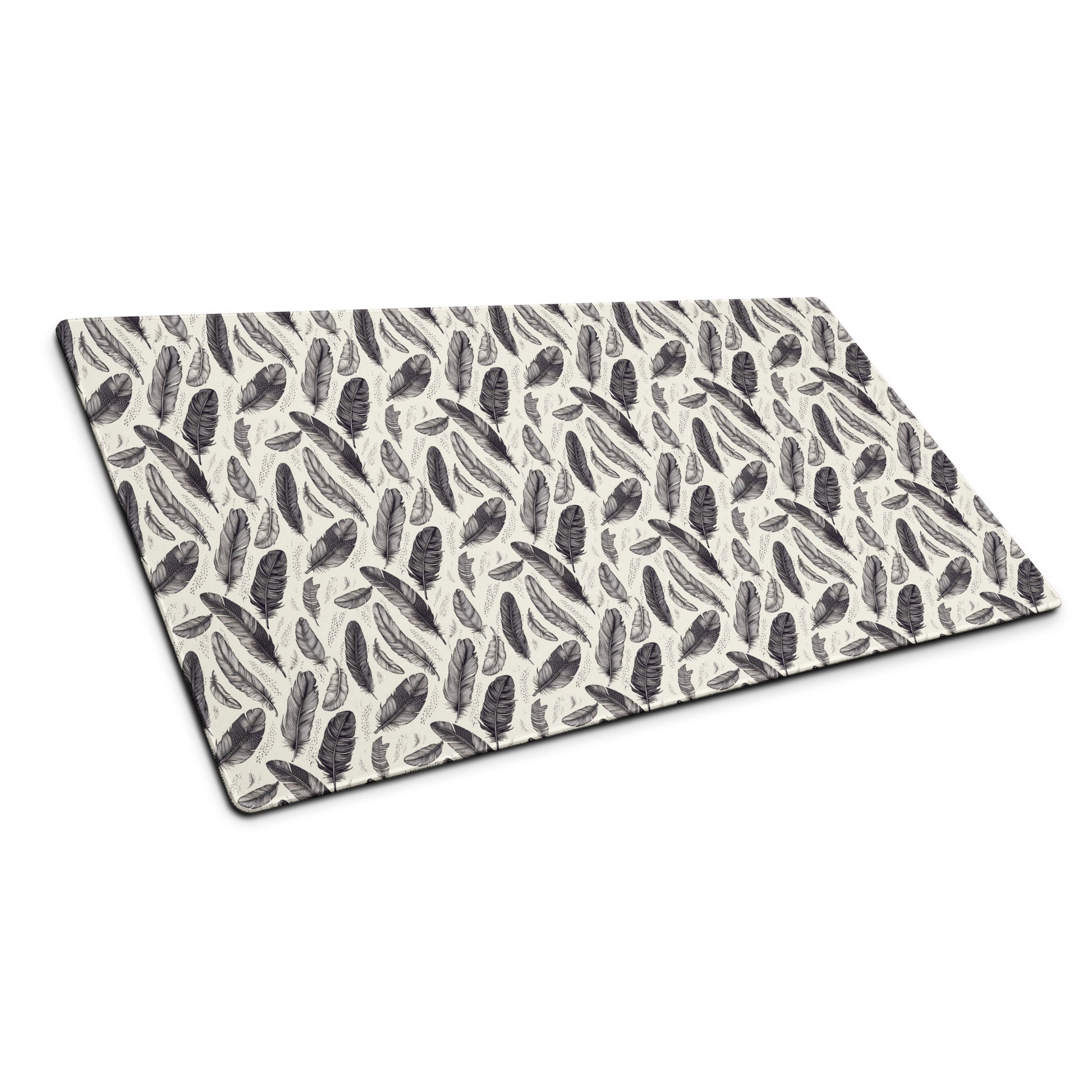 A 36" x 18" gaming desk pad with black and white feathers sitting at an angle.
