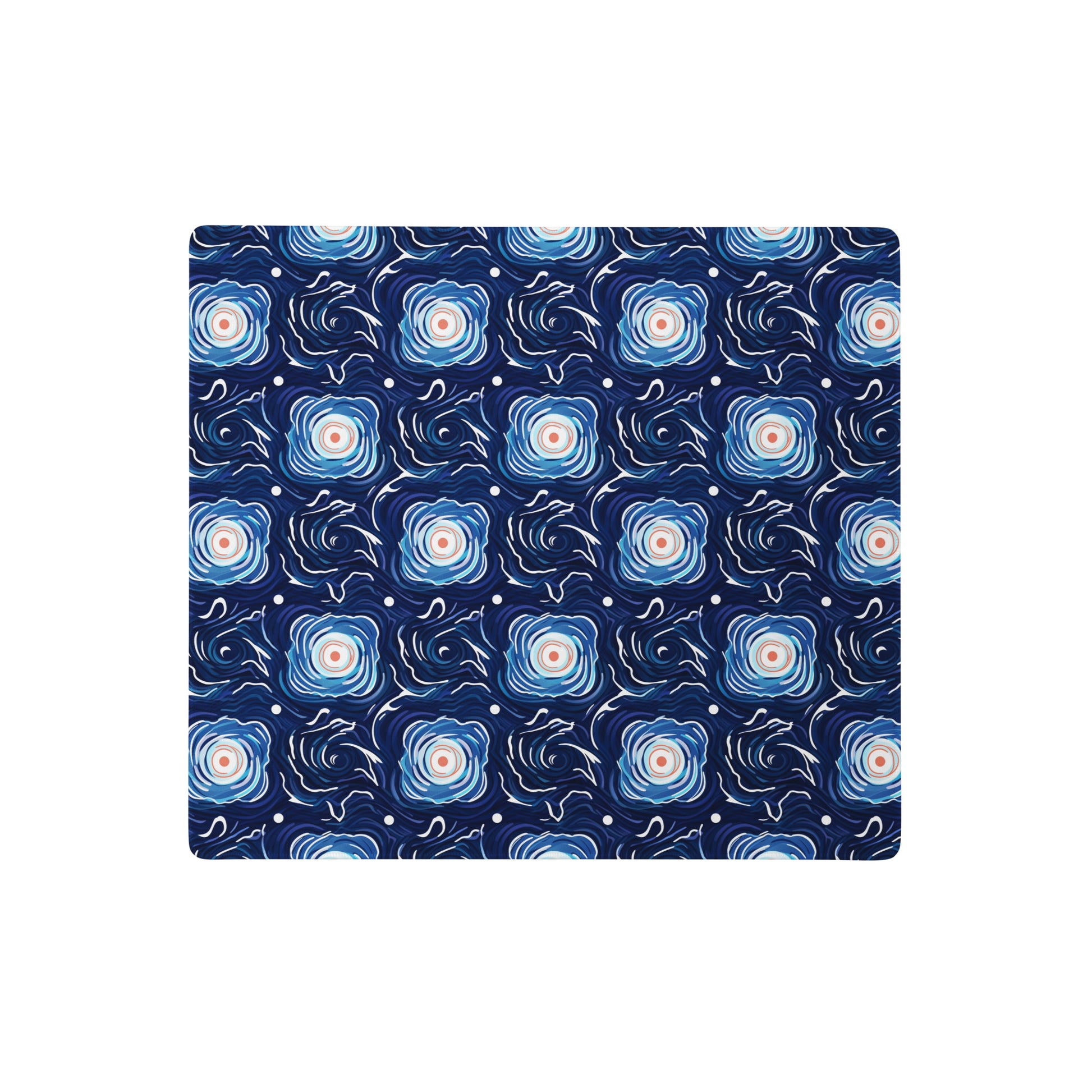A 18" x 16" desk pad with a blue and white floral pattern.