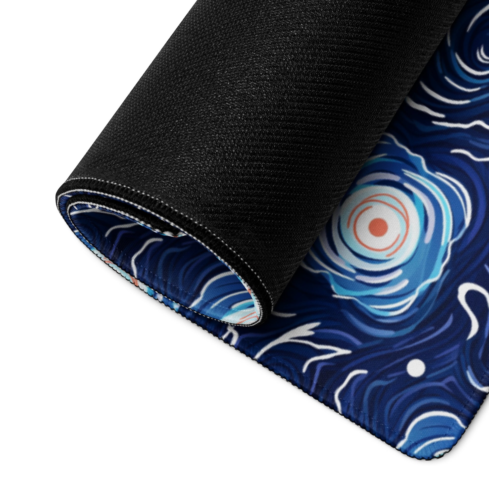 A 36" x 18" desk pad with a blue and white floral pattern rolled up.