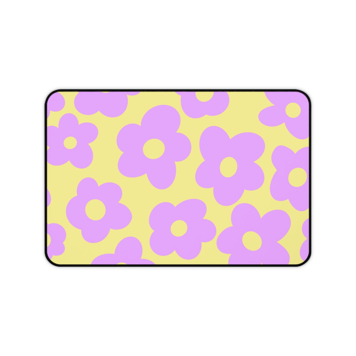 A 12" x 18" desk mat with purple flowers on a yellow background.